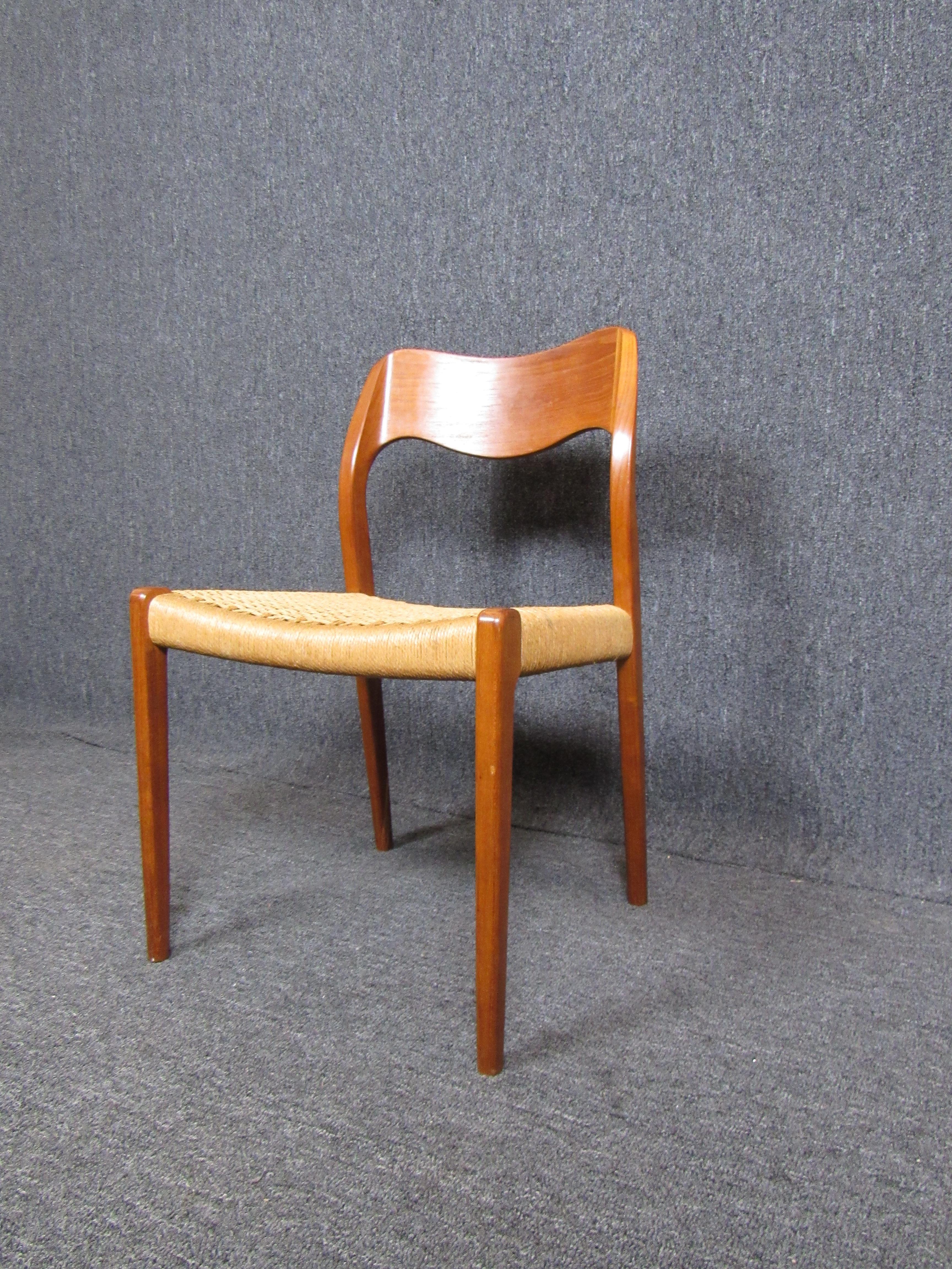 This elegant vintage chair can add a touch of Mid-Century Modern style to any space, with a woven papercord seat and sculpted teak frame. Moller furniture is made by a company founded in 1944 by Niels Otto Moller.

Please confirm item location with
