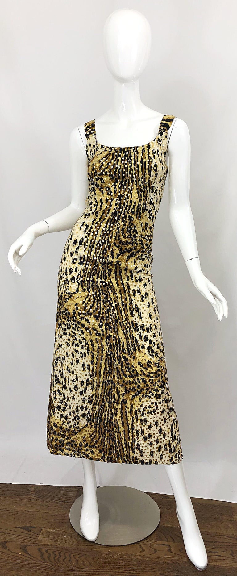 Chic early 70s MOLLIE PARNIS leopard / cheetah print sequined midi dress! Features classic leopard print with hundreds of 
hand-sewn gold and silver sequins throughout. Perfect weight cotton fabric. Full metal zipper up the back with hook-and-eye