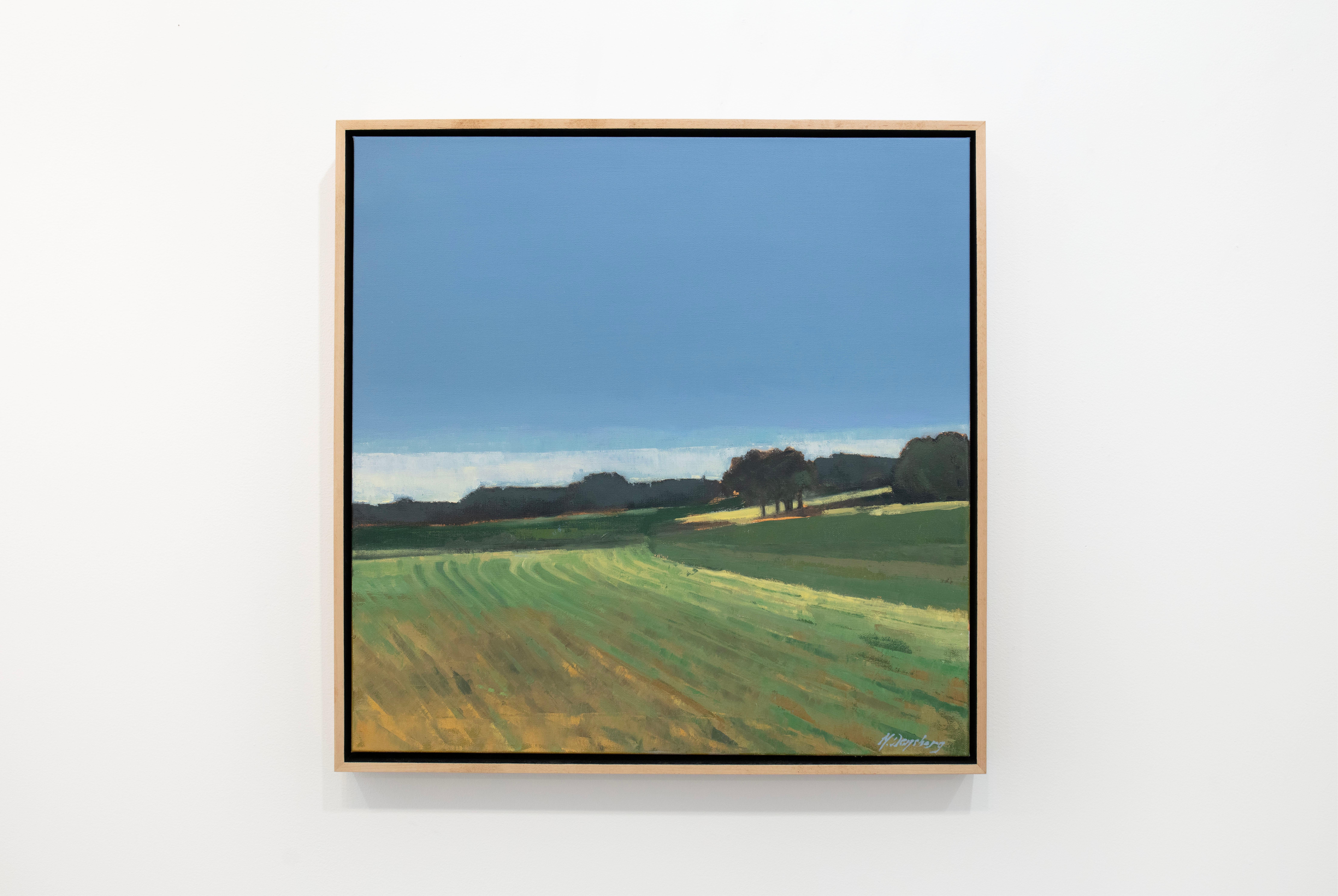 This abstracted landscape painting by Molly Doe Wensberg features a cool blue and green palette with warm yellow accents. The artist captures a scene of a field with lush foliage along the horizon beneath a clean blue sky. The painting itself is 24"