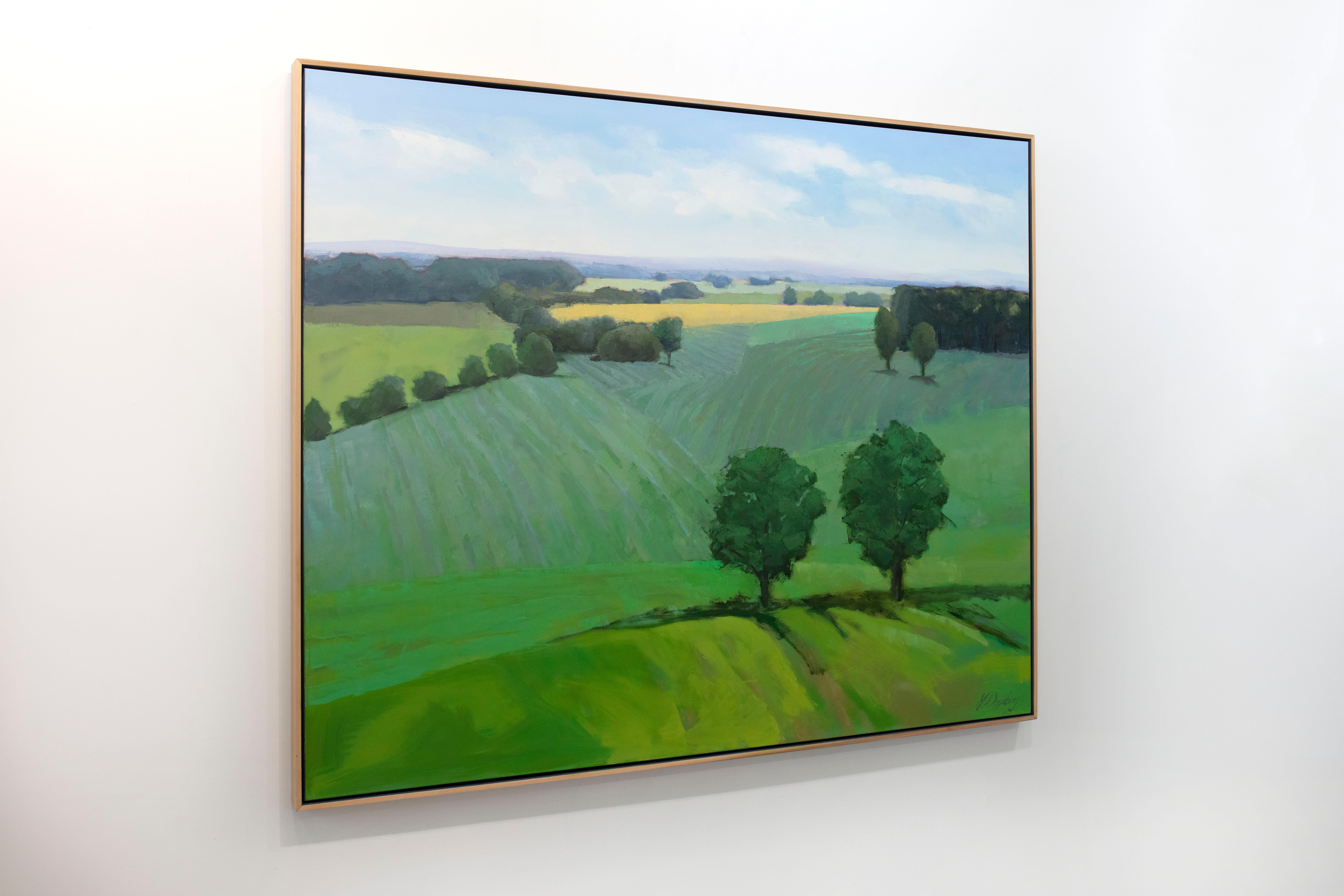 This large landscape statement painting by Molly Doe Wensberg features a cool green palette with warm yellow accents. It captures a landscape scene with lush foliage and rolling hills. The artist blends styles by abstracting various parts of the
