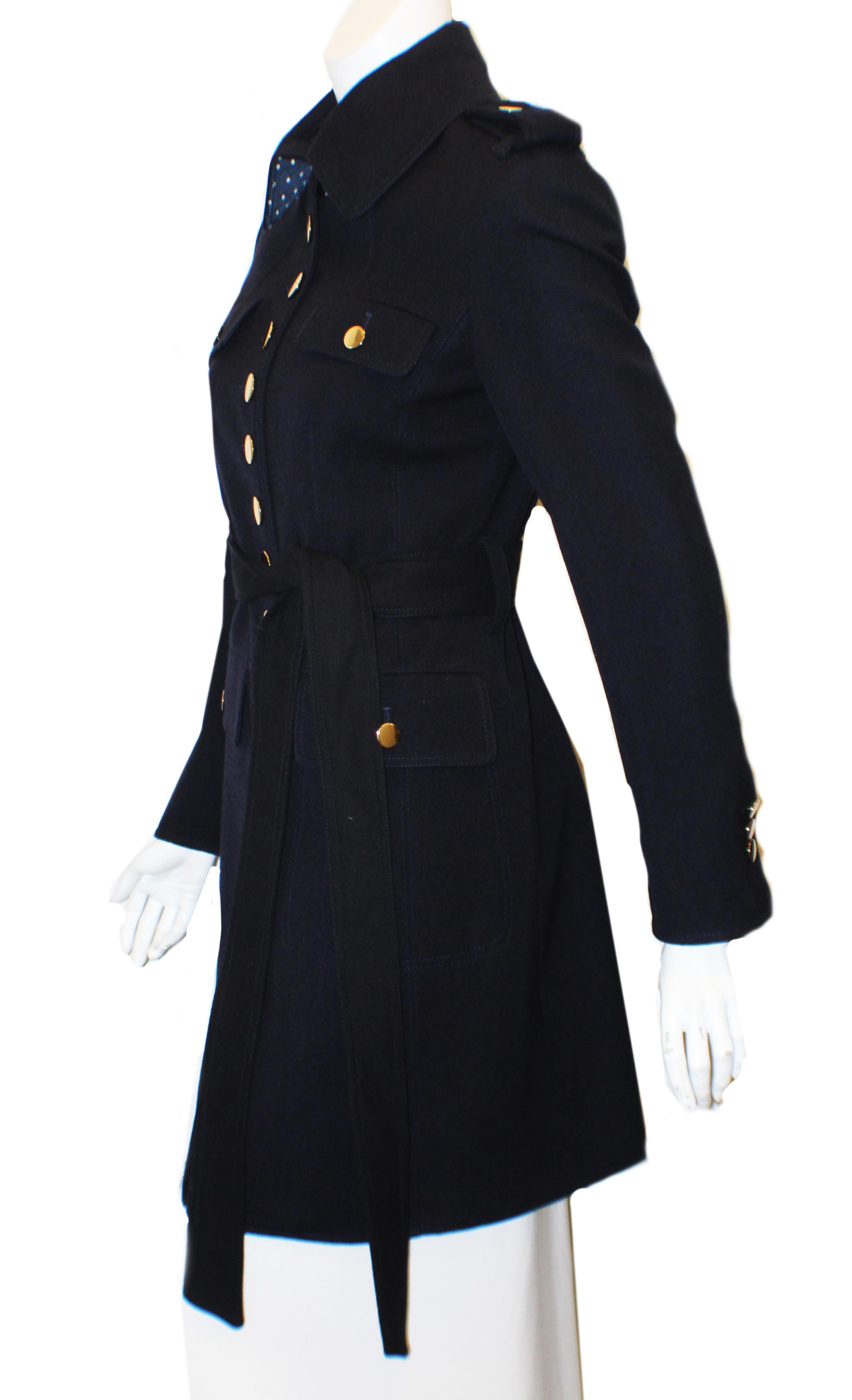 Moloh, a current designer from the United Kingdom, tends to make primarily military styled jackets, coats, and other stylish outerwear.  This beautiful 100% navy wool 3/4 coat is fashioned in the military style and comes from their 2014