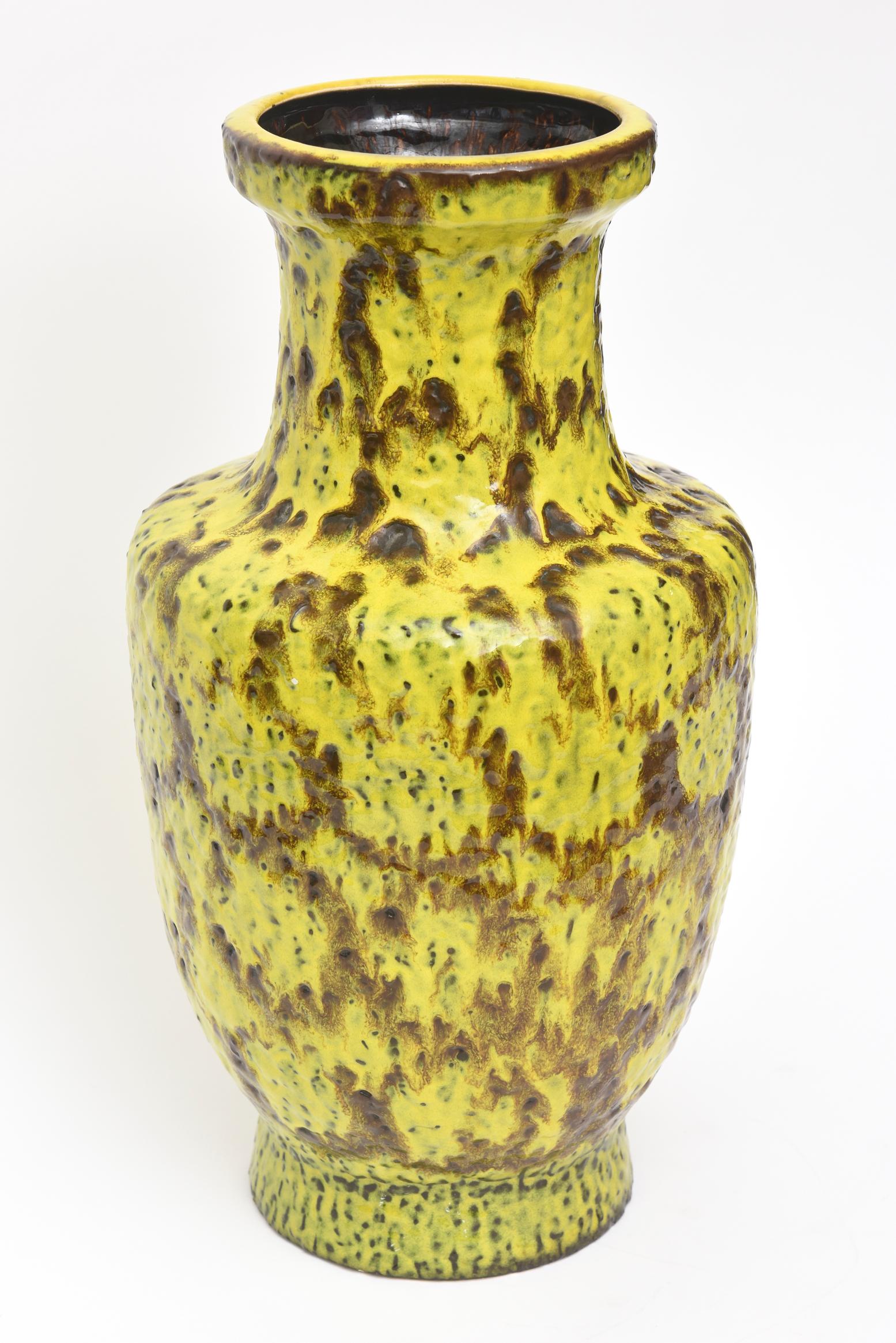 This gorgeous and monumental tall German Mid-Century Modern Bay Keramik molten fat glazed marbled ceramic vase or vessel sculpture has luscious colors of chartreuse yellow green and brown. It makes a statement and is signed on the bottom Bay W