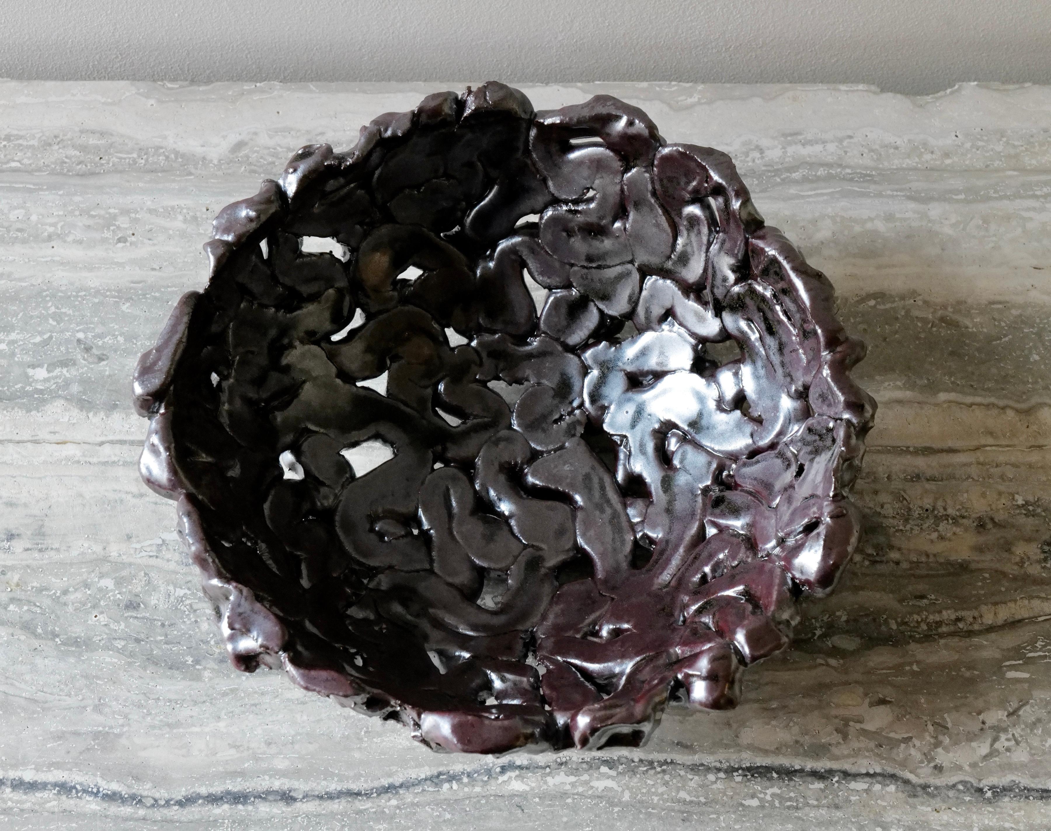 The Molten Flow Stoneware Bowl is a sculptural masterpiece that celebrates the raw, organic beauty of clay in motion. Handbuilt from durable stoneware, this bowl features a fluid, undulating surface that resembles cooled lava or molten metal