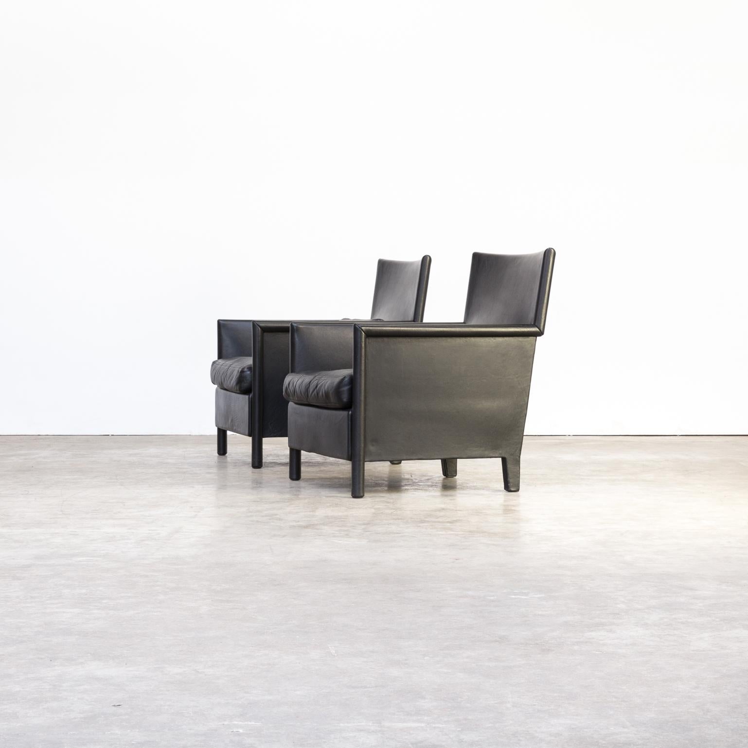 Highly comfortable set of two black leather fauteuils by the Italian workshop/studio Molteni & Co. The frame of the chairs have been wrapped in leather and the arm leggers are in small though comfortable rounded leather. Beautiful detailed design.