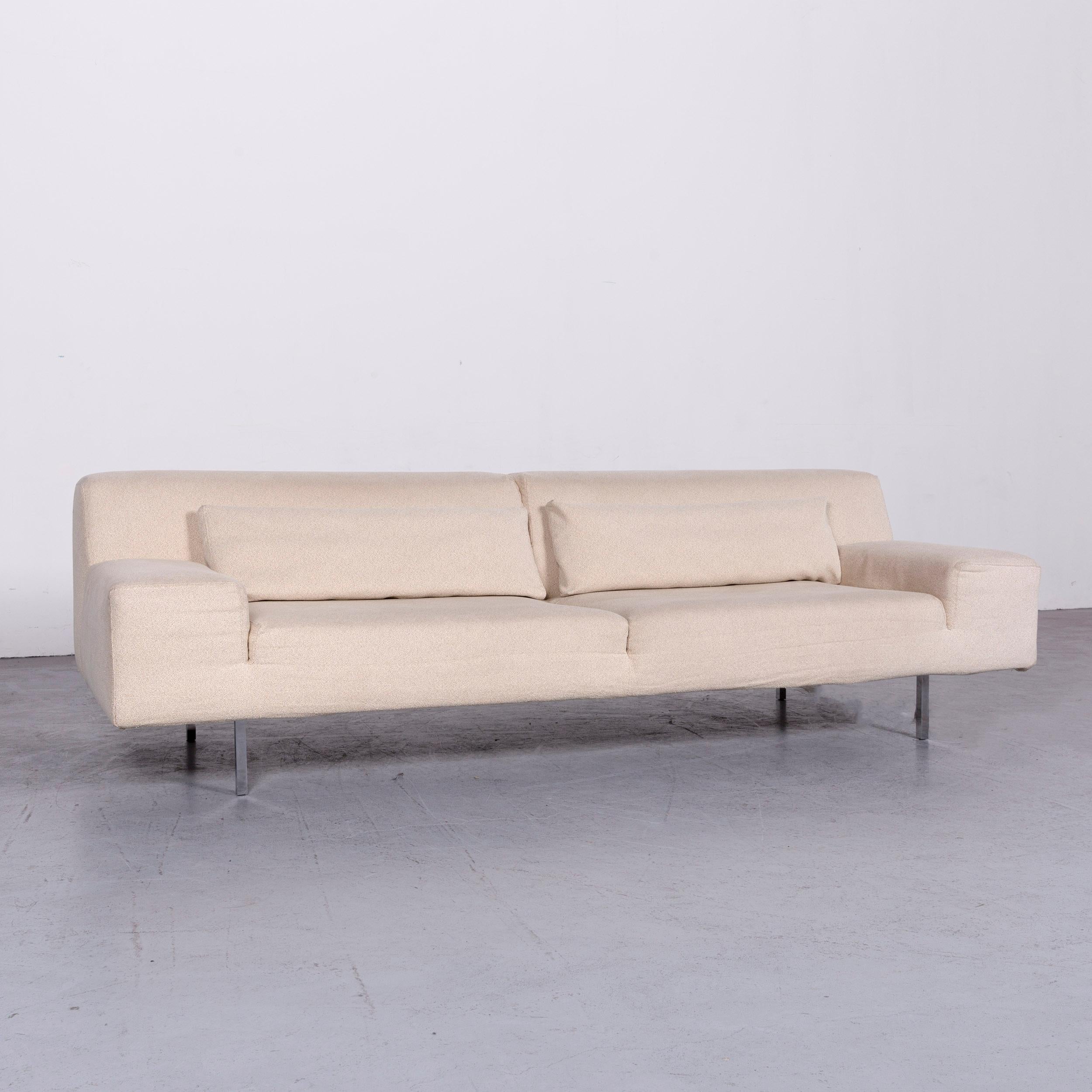 We bring to you a Molteni designer fabric sofa footstool set crème three-seat couch.