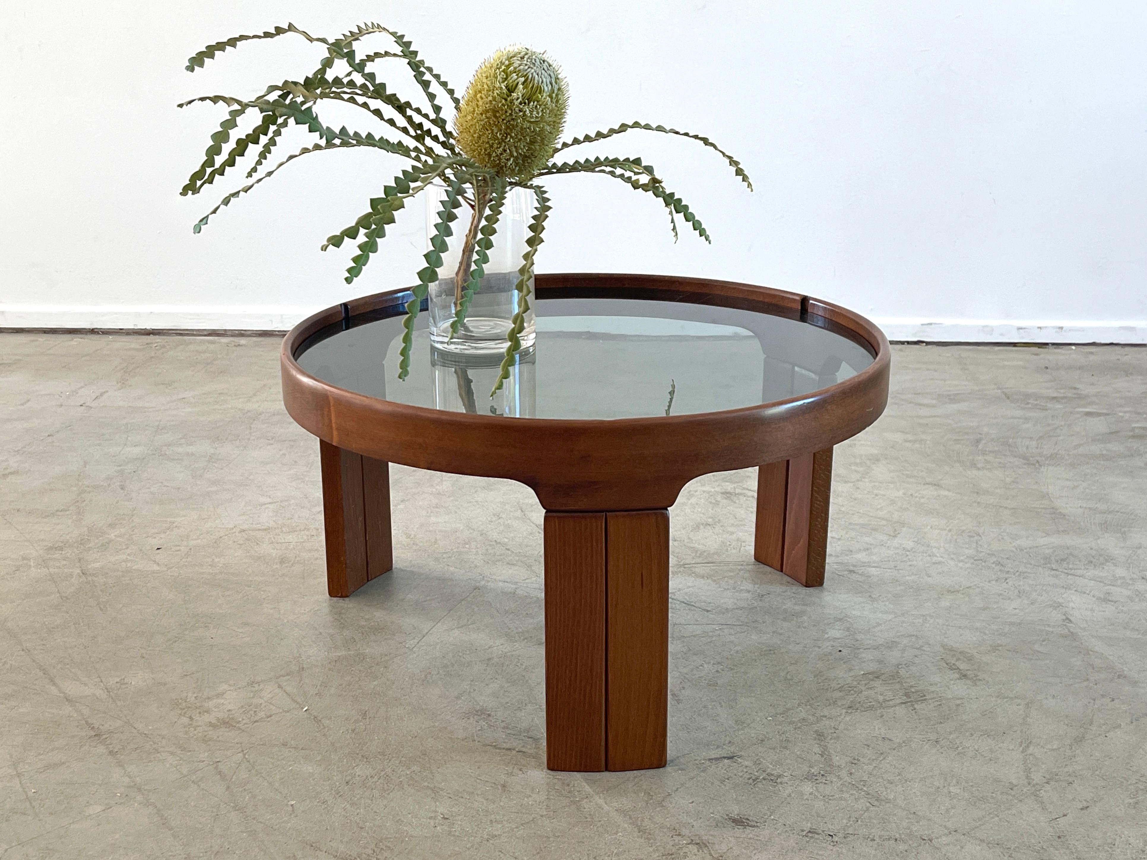 Beautifully simple Italian side table by Molteni. 
Mahogany tripod circular base with smoked original glass top.