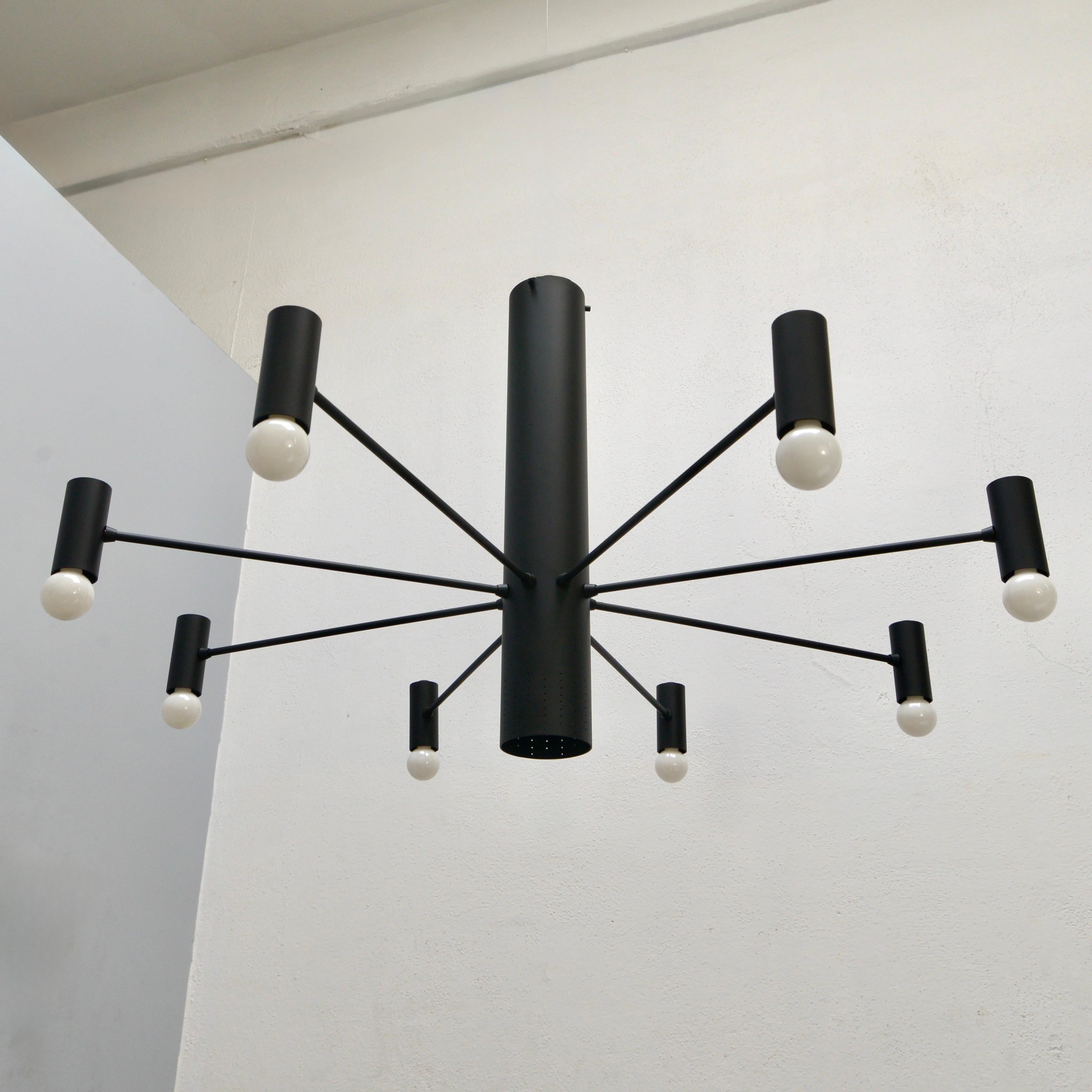 Part of Lumfardo Luminaires contemporary collection, the MoLUno chandelier fixture is an elegant 8 light chandelier made from black painted aluminum and brass. The light is wired with eight E12 medium based sockets and 1 E26 illuminating downward
