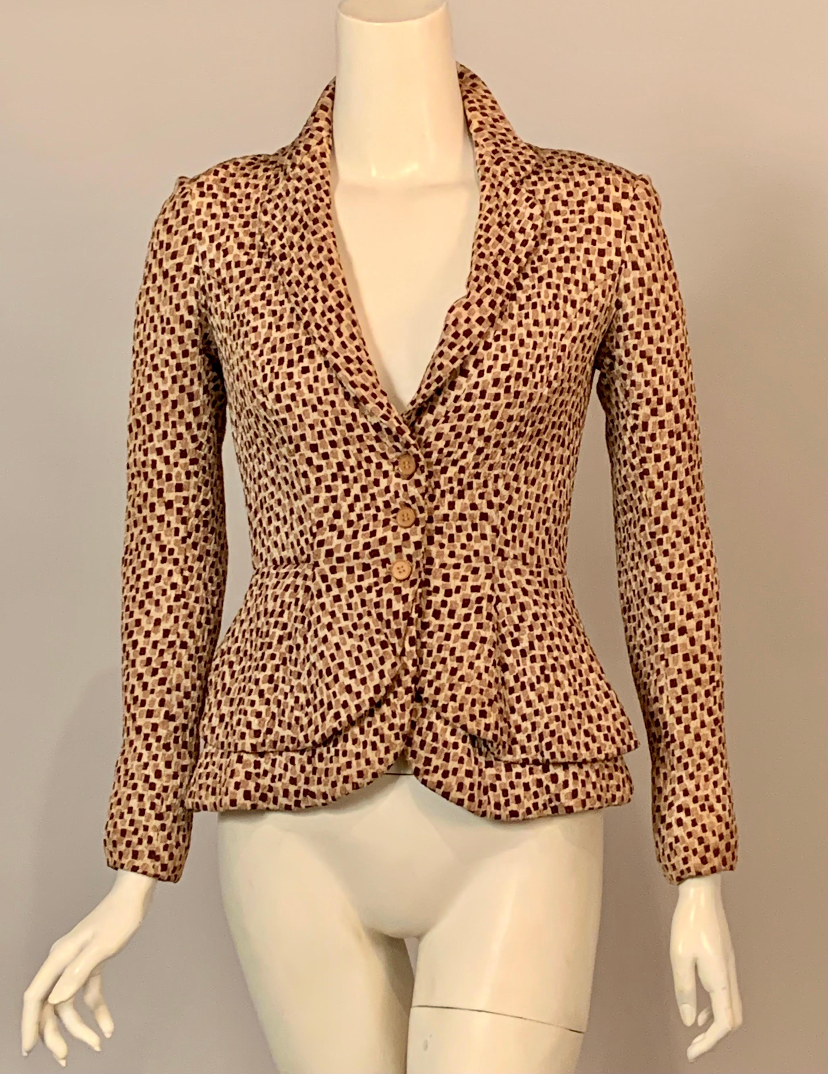 This is a great example of French haute Couture from the 1940's.  Edward Molyneux chose a modern fabric design and padded the shoulders as well as the peplum of this three button jacket.  The label is missing but it is easy to identify it as