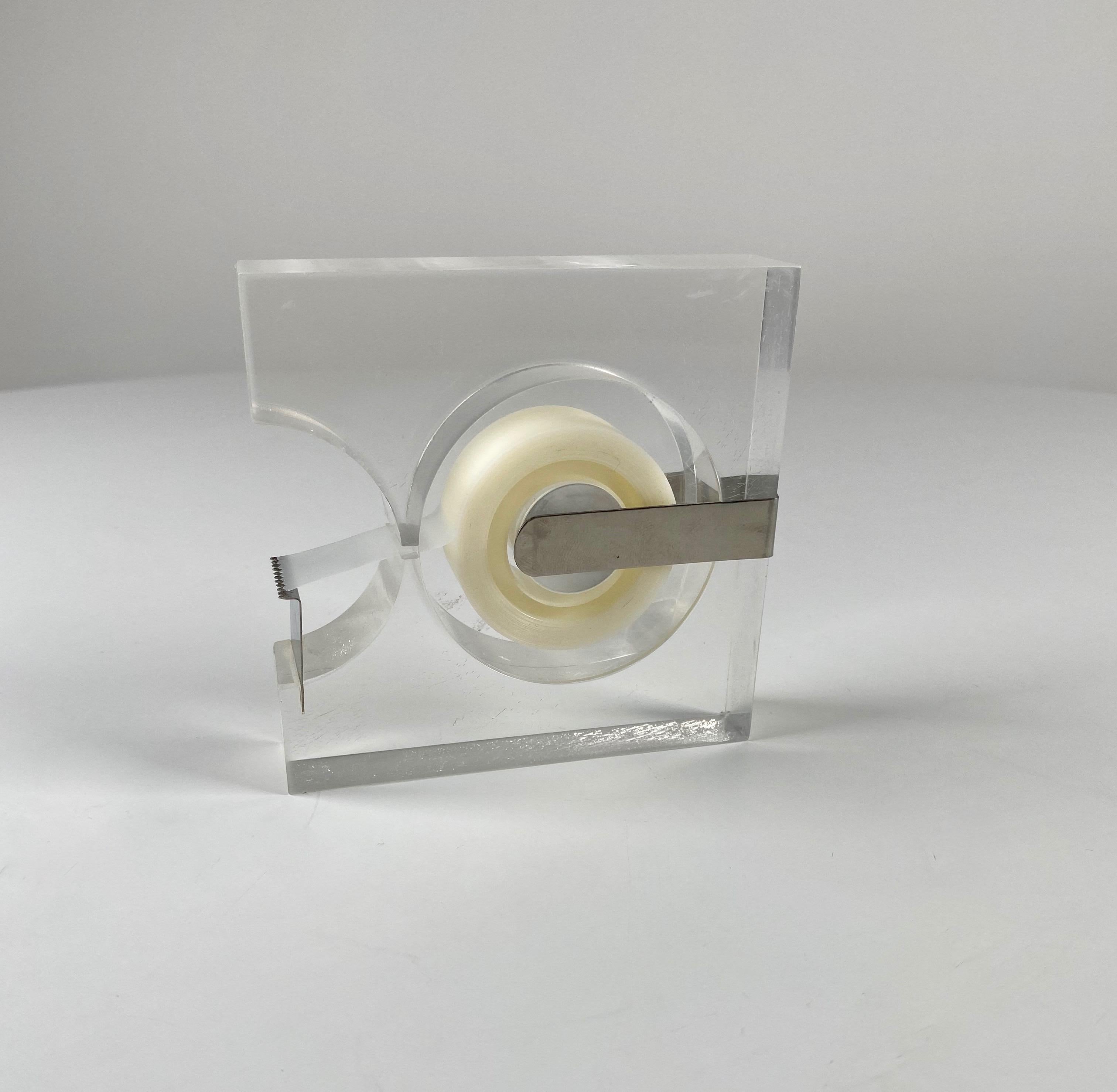 Lucite and chrome tape dispenser produced from (1963 to 1973) by Two's Company of Mount Vernon, New York. Created by Industrial Designer Robert P. Gottlieb, this dispenser was part of the MoMA, NY Design Study Collection. Constructed of a solid
