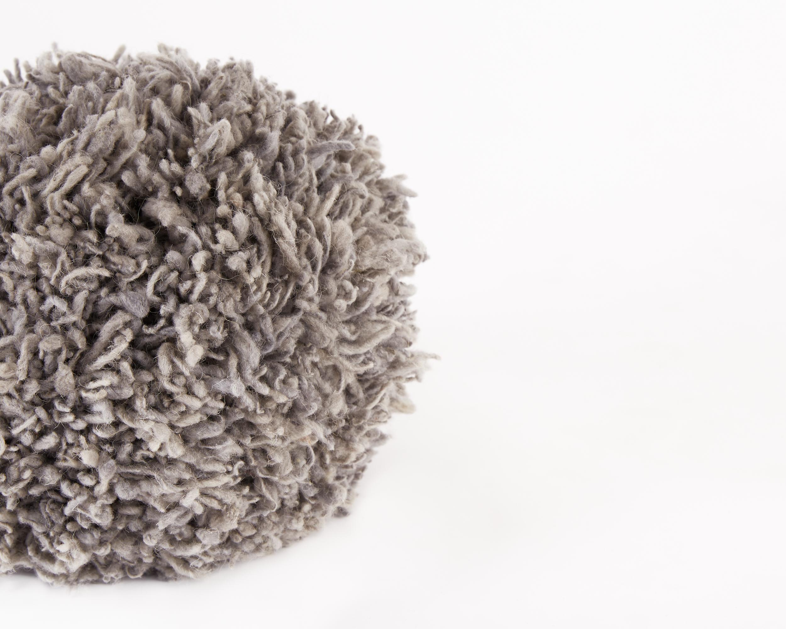 The Momo in Silver is part of our newest homeware collection. It is made completely out of natural wool sourced from Momostenango, Guatemala. Each one of them is hand-made using the traditional pom-pom technique, creating a very playful accessory to