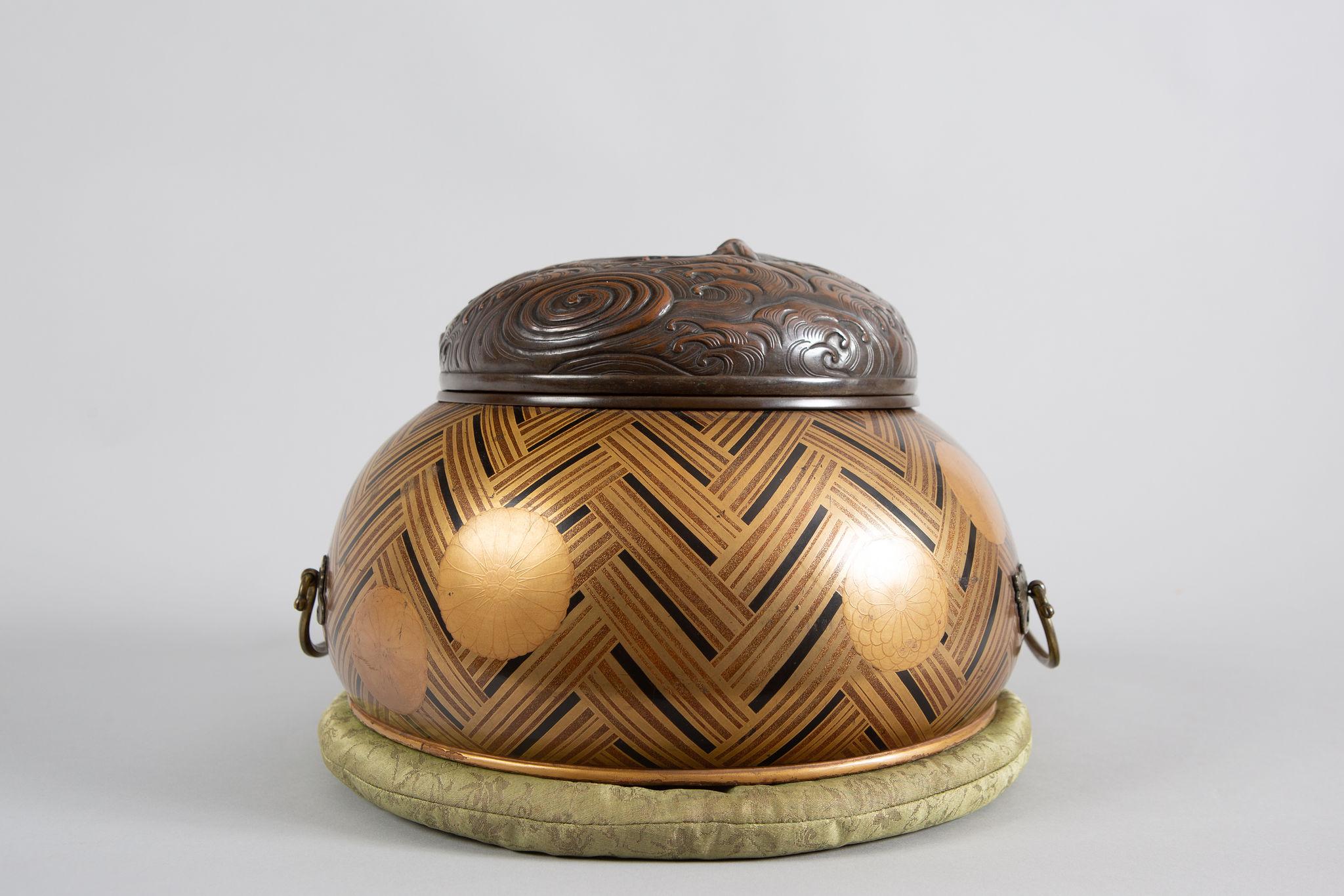 Early 17th century incense burner( Koro) in basket weave nashiji lacquer pattern with chrysanthemum mons (the national symbol of Japan). Copper grill with detailed waves pattern. Footed with mounts. Comes with pillow and original storage box.
