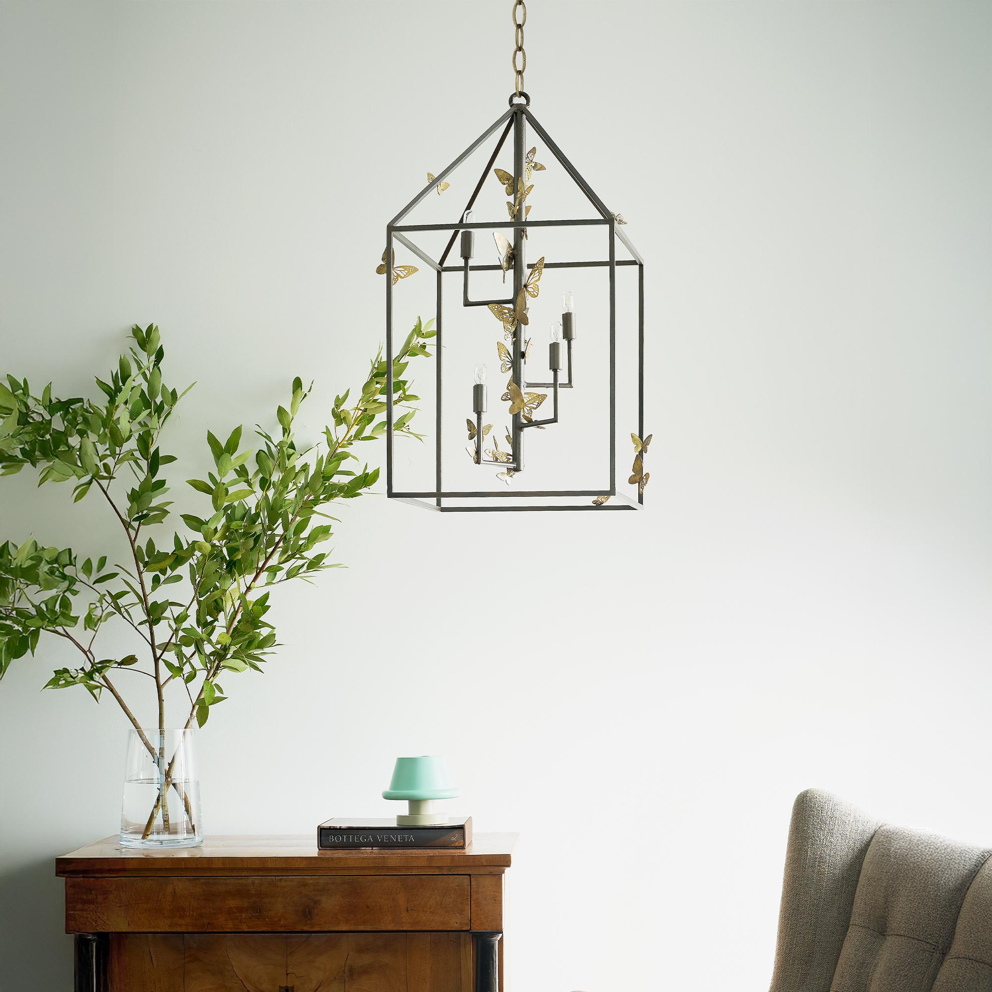 Embellished with whimsical butterflies in a captivating arrangement, the Monarch Lantern brings a touch of charm to any space it graces. Designed as a hanging light fixture, this enchanting piece features delicately crafted butterflies that appear