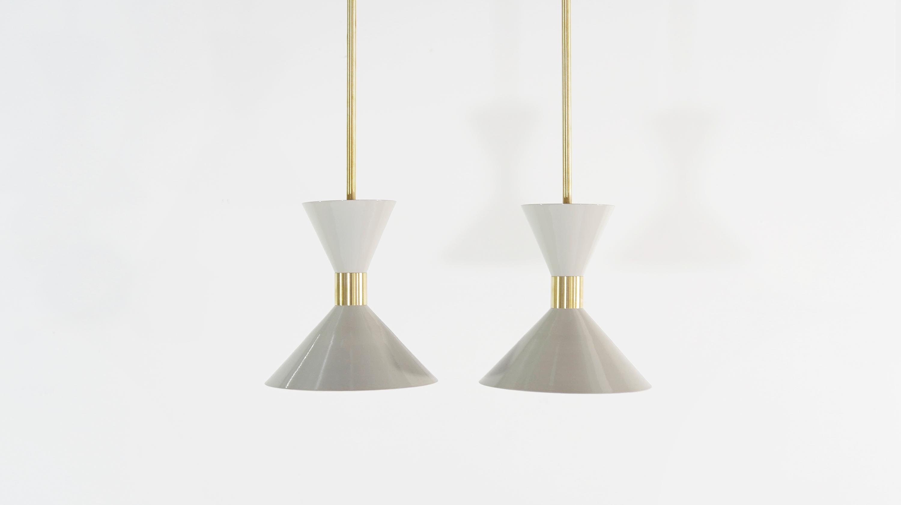 The wide brass band and dramatically scaled flared cone makes the Monarch a strong design statement. This design is strongly influenced by both French and Italian Mid-Century Modernism.
 
Shown in brass and 