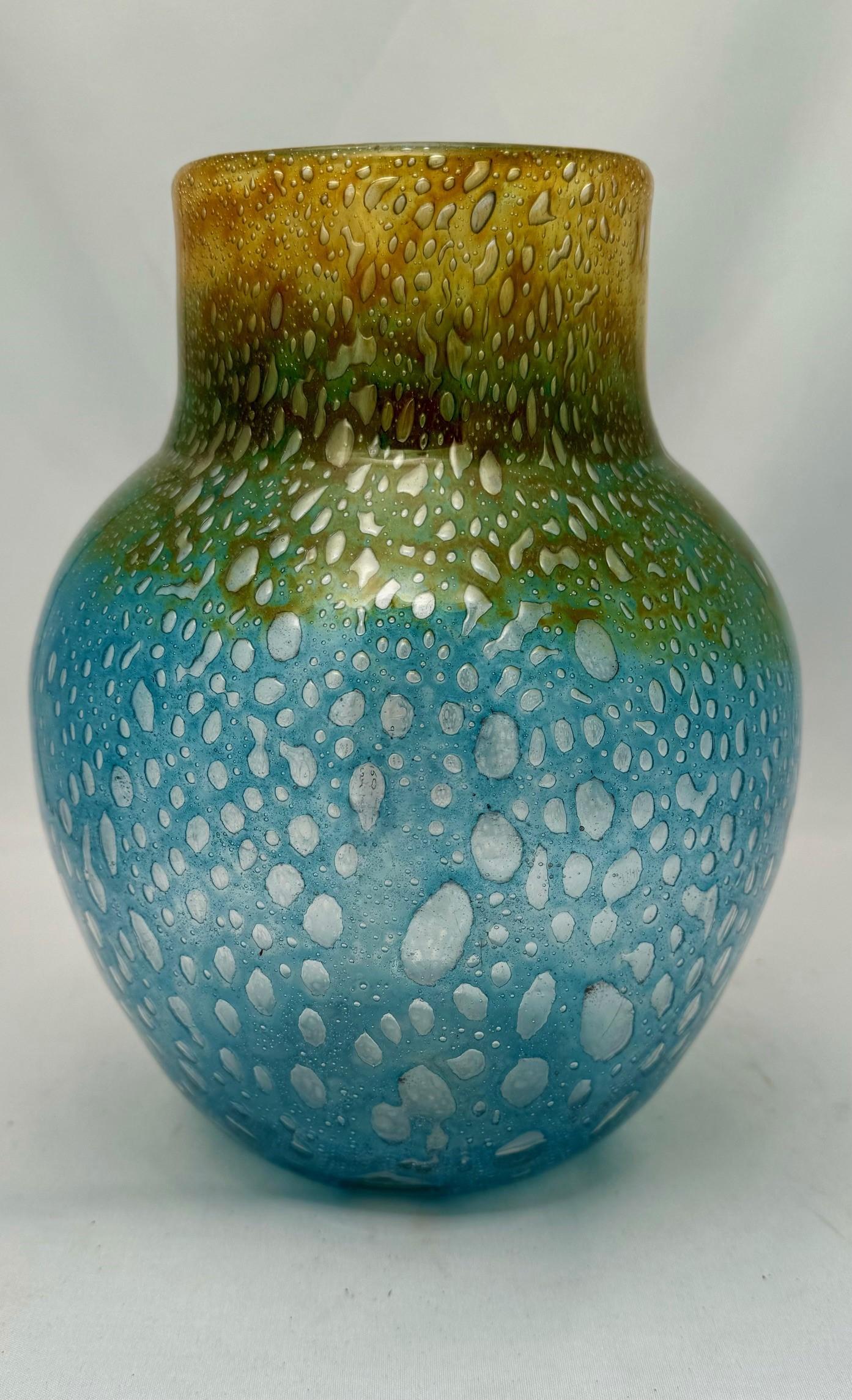 This large Monart vase with entrancing colors and textures,
the blue ground with evolving clear bubbles rise to the top in a fizzing amber fusion. Beauty in glass suitable for a stand alone piece or in collection.
