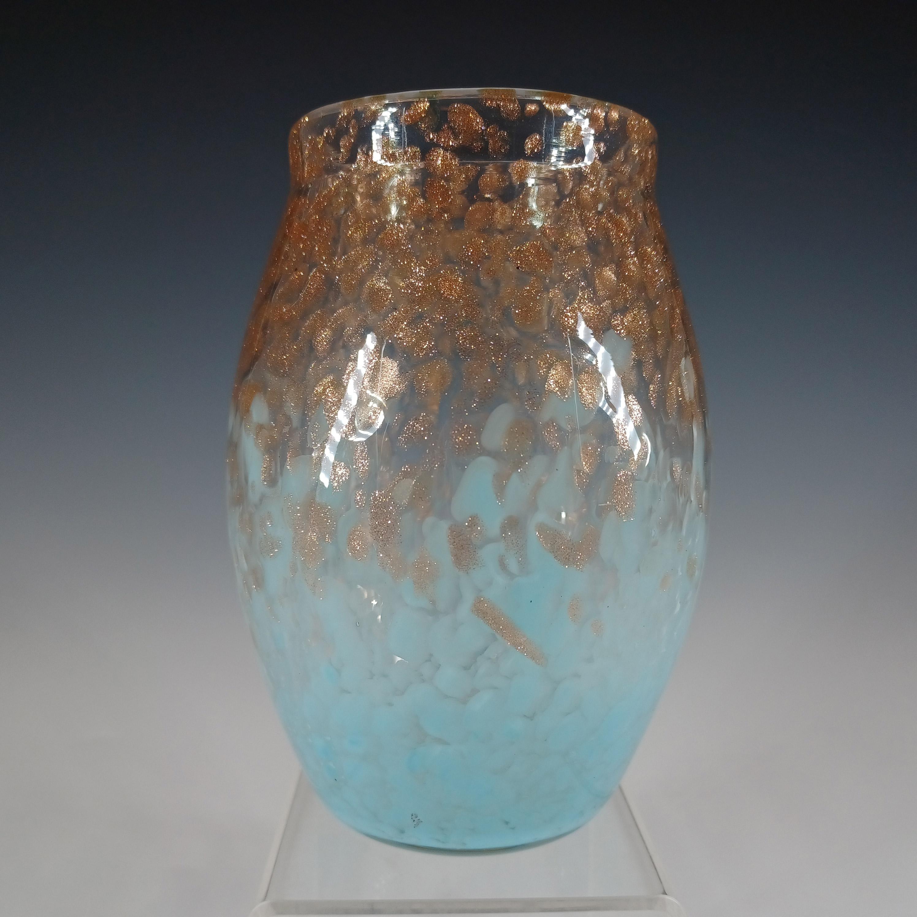 Un petit vase Monart en verre chiné bleu pâle avec des mouchetures d'aventurine de cuivre. Fabriqué par l'usine écossaise Moncrieff's dans les années 1930/40, numéro de forme MF. Non marquée, elle présente la finition classique de la base Monart