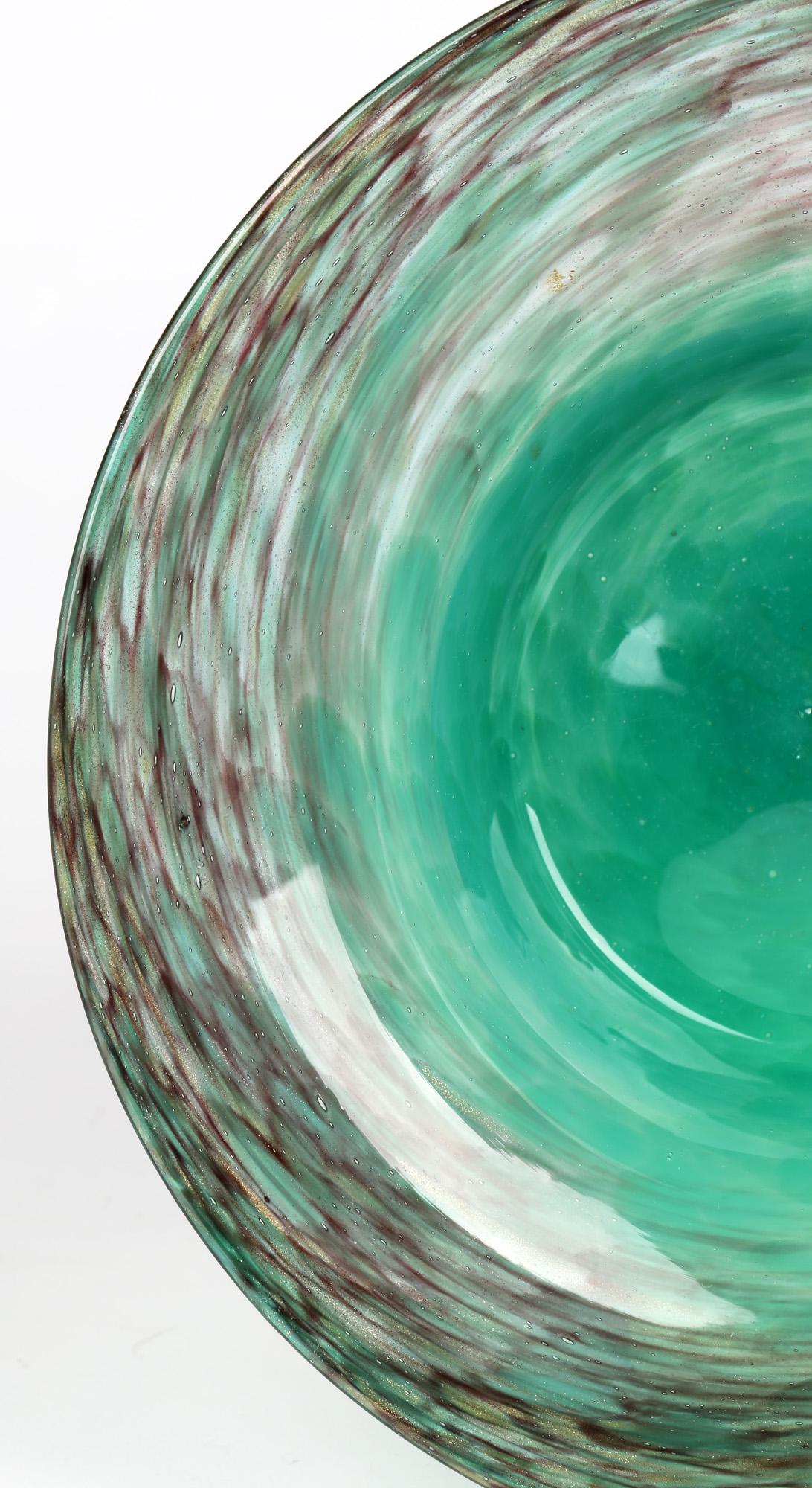 A good quality Scottish Art Deco glass bowl with bright turquoise and gold aventurine swirl patterning by Monart. The rounded art glass bowl has a recessed centre with a wide rim and has a bright mottled turquoise glass centre with a swirling