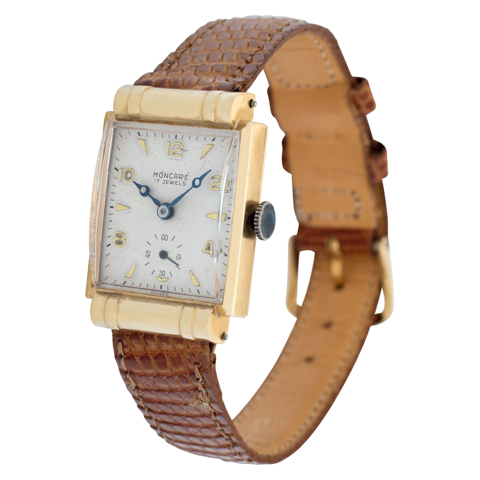 Unisex vintage Moncare 14k yellow gold case, 14k yellow gold bezel with lizard leather brown band with gold filled tang buckle. Manual wind Fine Pre-owned Moncare Watch. Certified preowned Vintage Moncare Classic watch is made out of yellow gold on