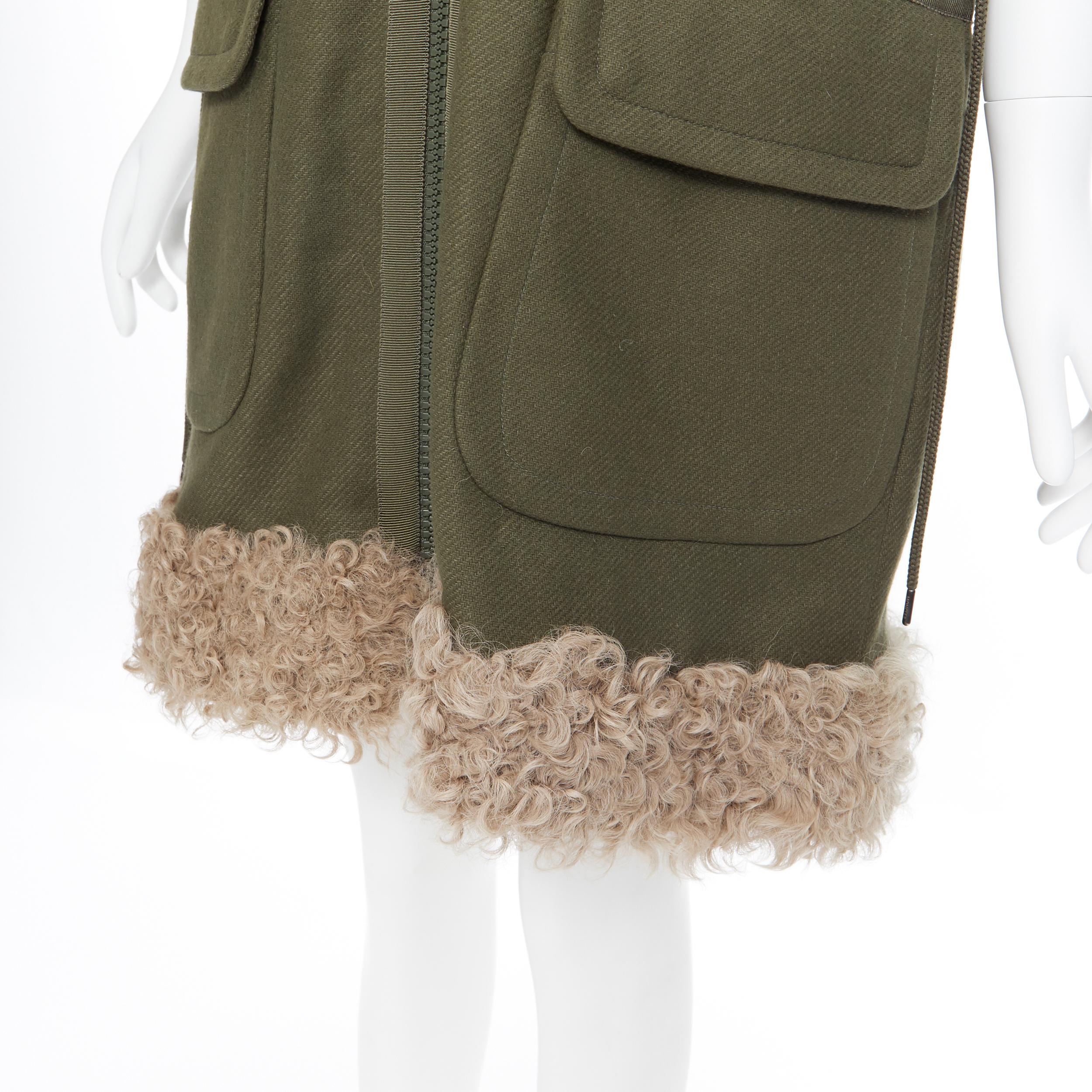 MONCLER Anne Giubbotto military green down padded shearling trim hooded vest S
Brand: Moncler
Model Name / Style: Down vest
Material: Nylon
Color: Green
Pattern: Solid
Closure: Zip
Extra Detail: Shearling and fur trimming at collar and at hem.