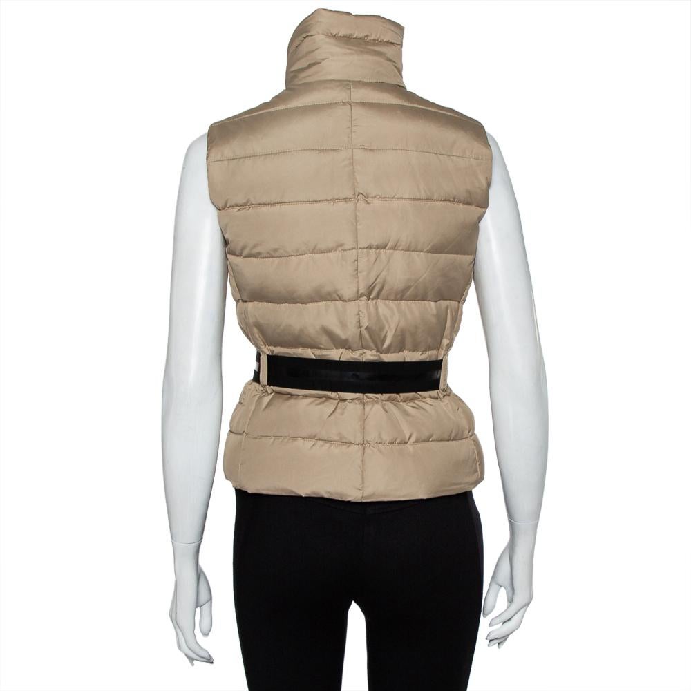 This vest by Moncler is aimed to provide comfortable luxury through clothing. Made to be lasting, the padded vest for women features front zip closure, zip pocket details, and a belt.

Includes: Belt