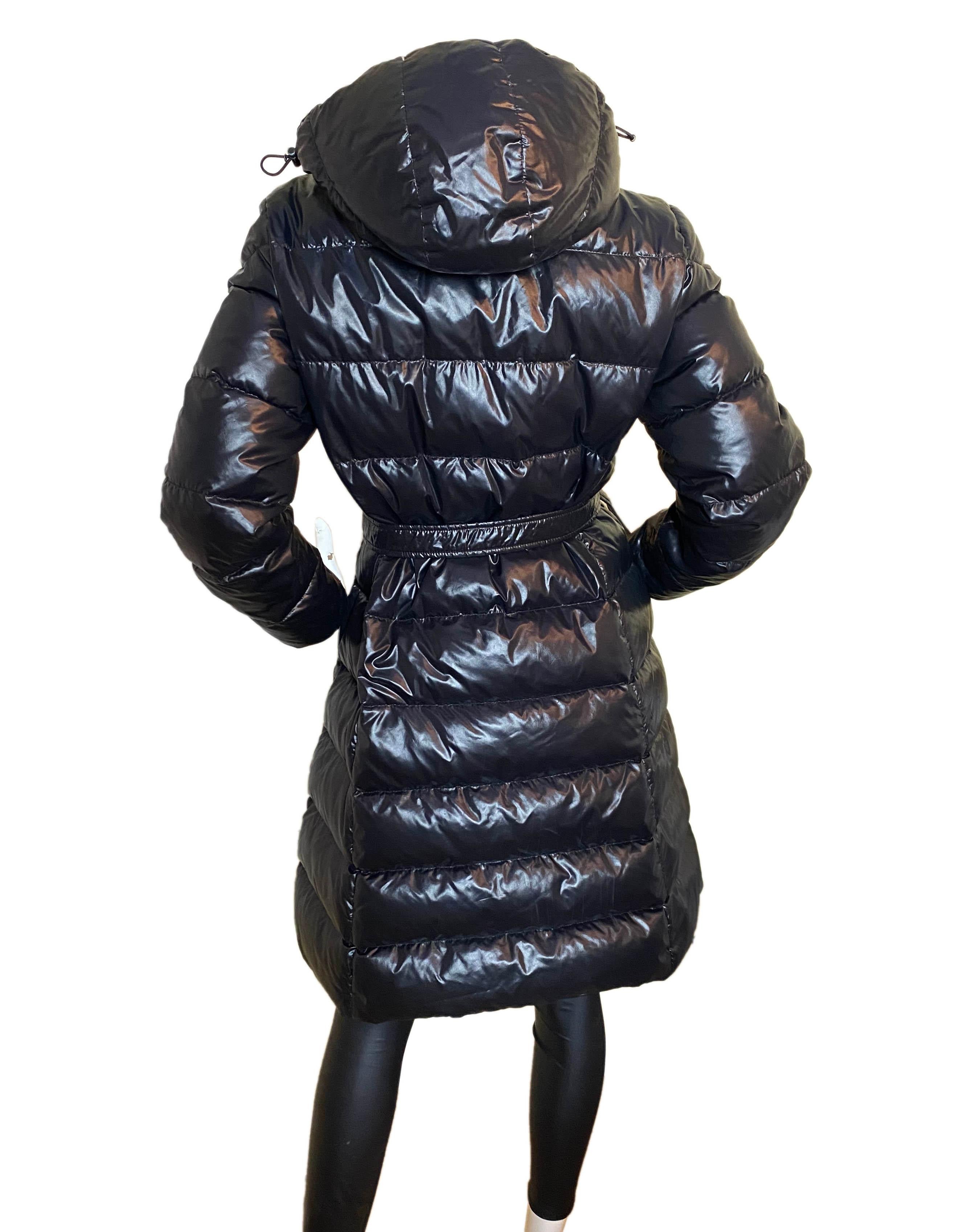 Moncler Meina Puffer Down Coat w/Belt & Detachable Hood

Made In: Hungary
Color: Black
Materials: Nylon
Lining: Nylon
Opening/Closure: Snap
Overall Condition: Very Good - peeling to snaps, missing cartoon inside
Includes: Hood, belt

Tag Size: