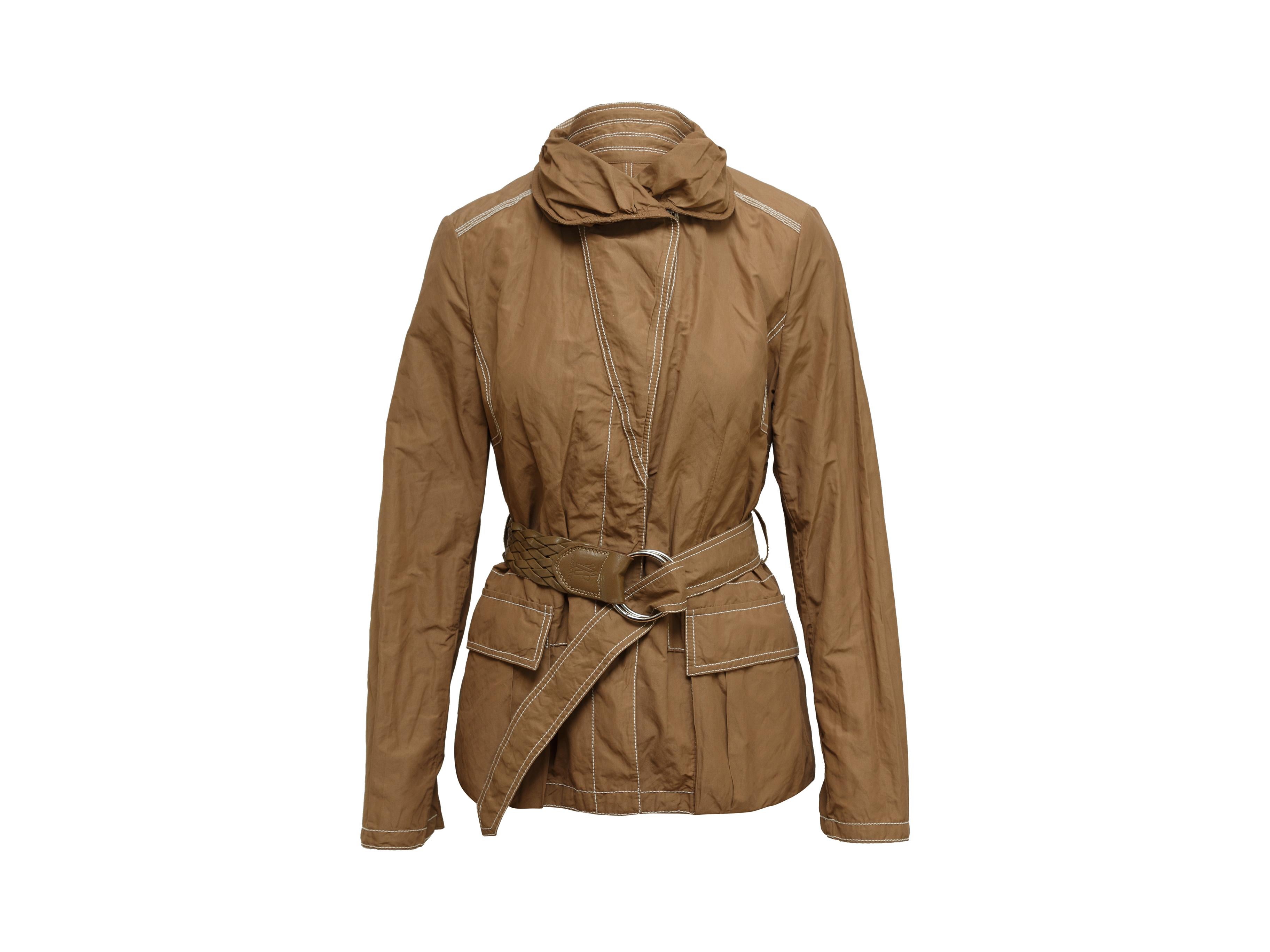 Product details: Brown lightweight jacket by Moncler. Contrast stitching throughout. High neck. Dual pockets at hips. Leather-accented leather belt at waist. Designer size 2. 36