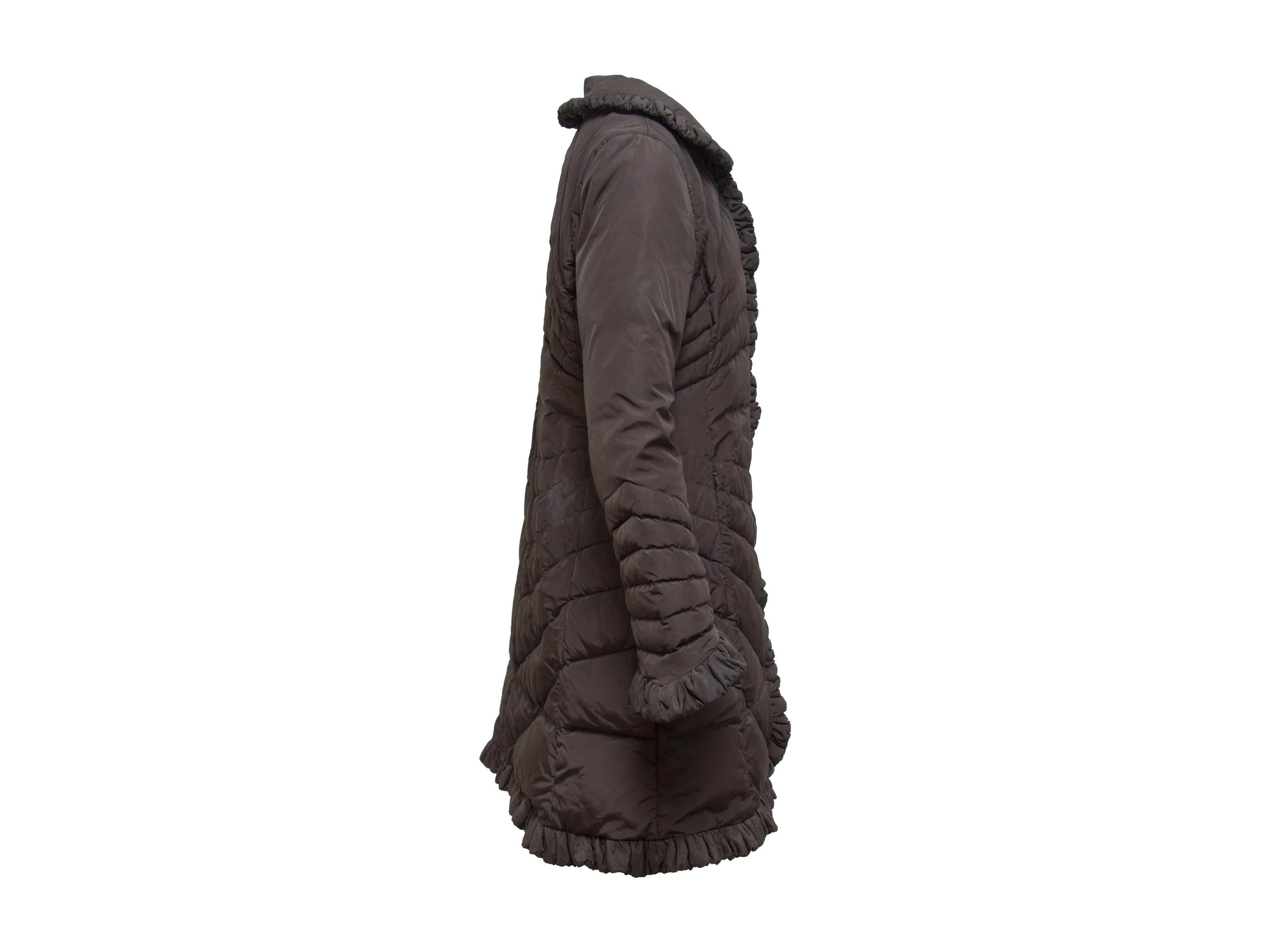 Product details: Brow Moncler Ruffle Trim Coat. Quilted coat has a ruffle trimmed Peter Pan collar, ruffle trim on cuffs and hem. Two front zippered pockets.  38