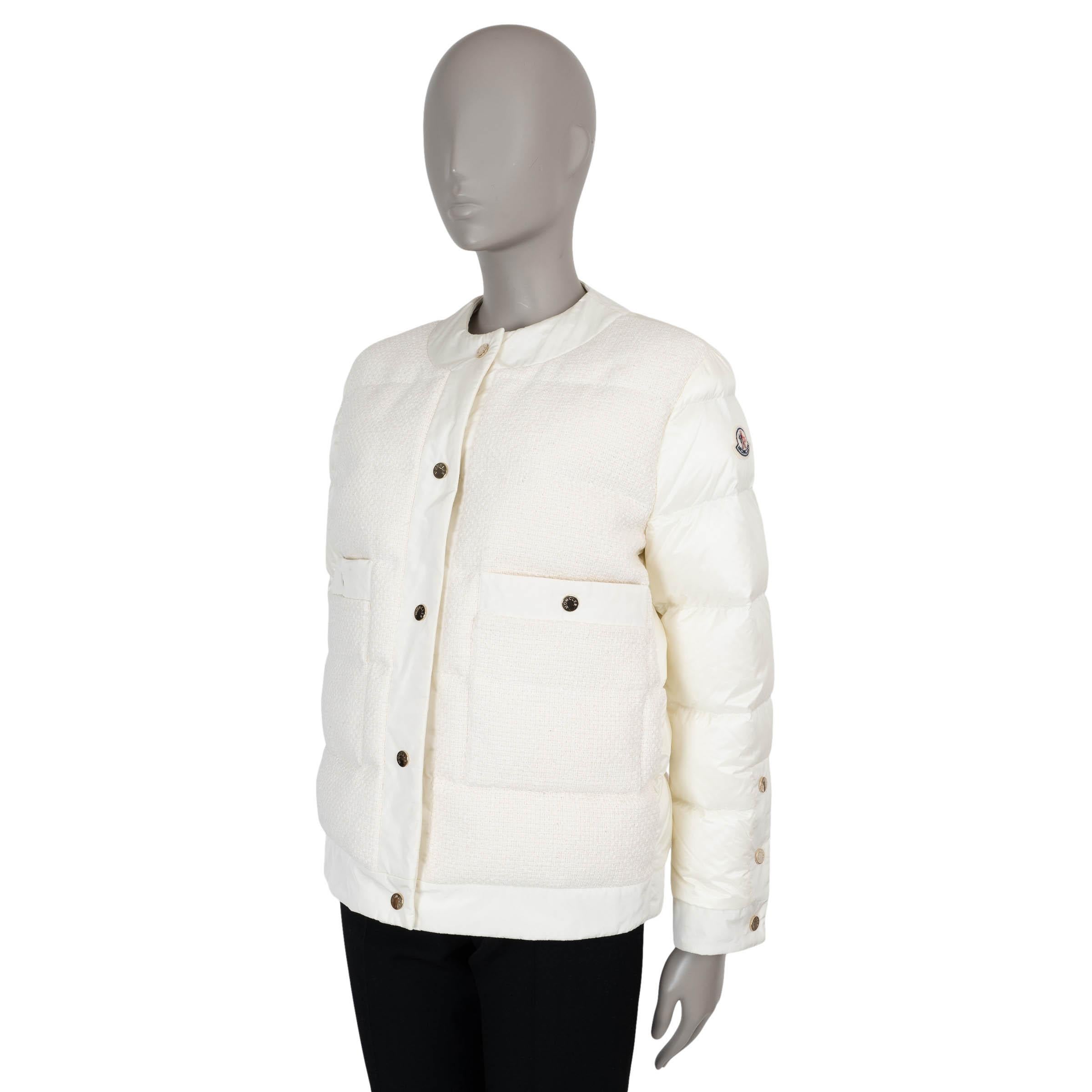 This 100% authentic Moncler Miriam jacket in cream quilted tweed cotton (59%), viscose (41%), and polyamide (100%) blends heritage texture with signature warmth. Designed with a boxy, cropped silhouette, it features a collarless round neck, two