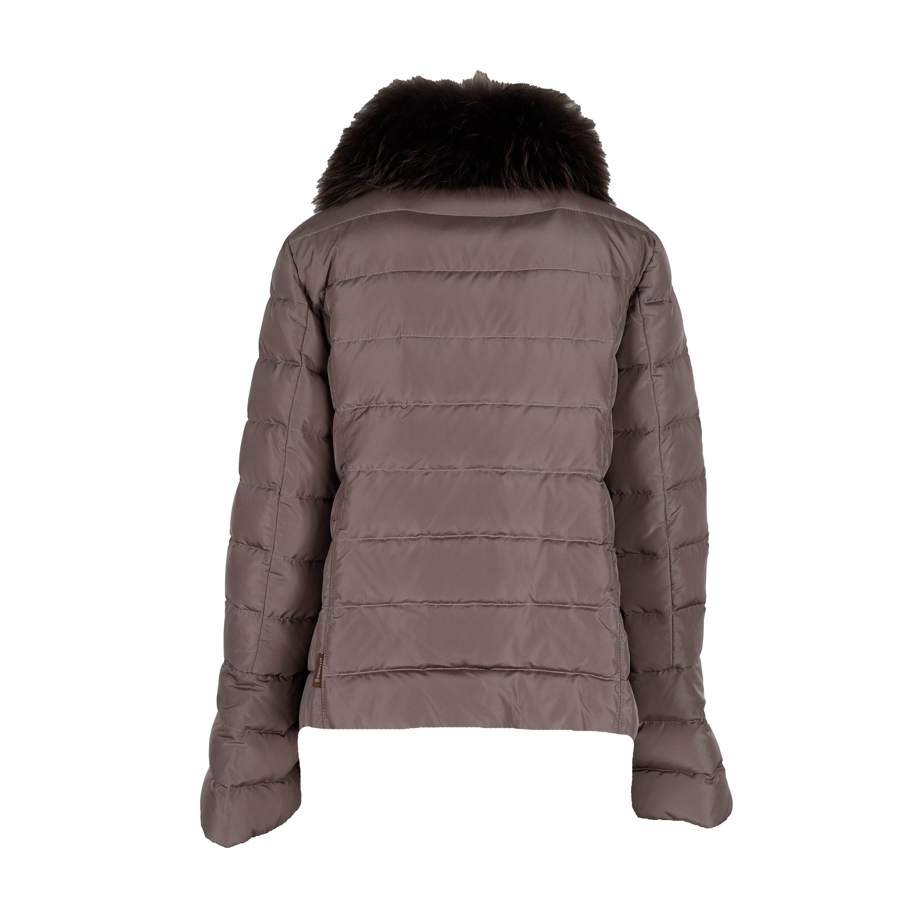 This Moncler down jacket offers both style and functionality with its light brown shade and animal fur trim along the stand collar. Equipped with zip pockets and snap button closure, this jacket will keep you warm and fashionable in any weather.