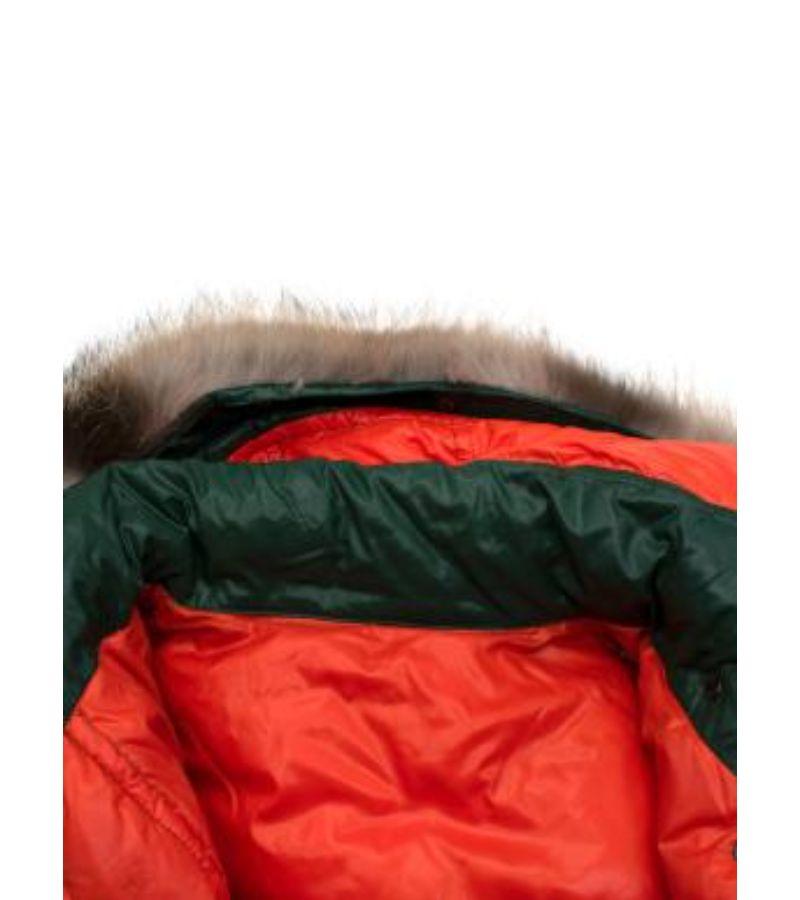 Moncler Escallonia Guibbotto Fox Fur Trim Down Jacket

- Smooth shiny body
- Puffer style
- Fox fur hooded trim 
- Slip and patch pockets with popper fastening 
- Draw string waist fastening 
- Draw string hem 
- Neon orange lining 
- Front popper