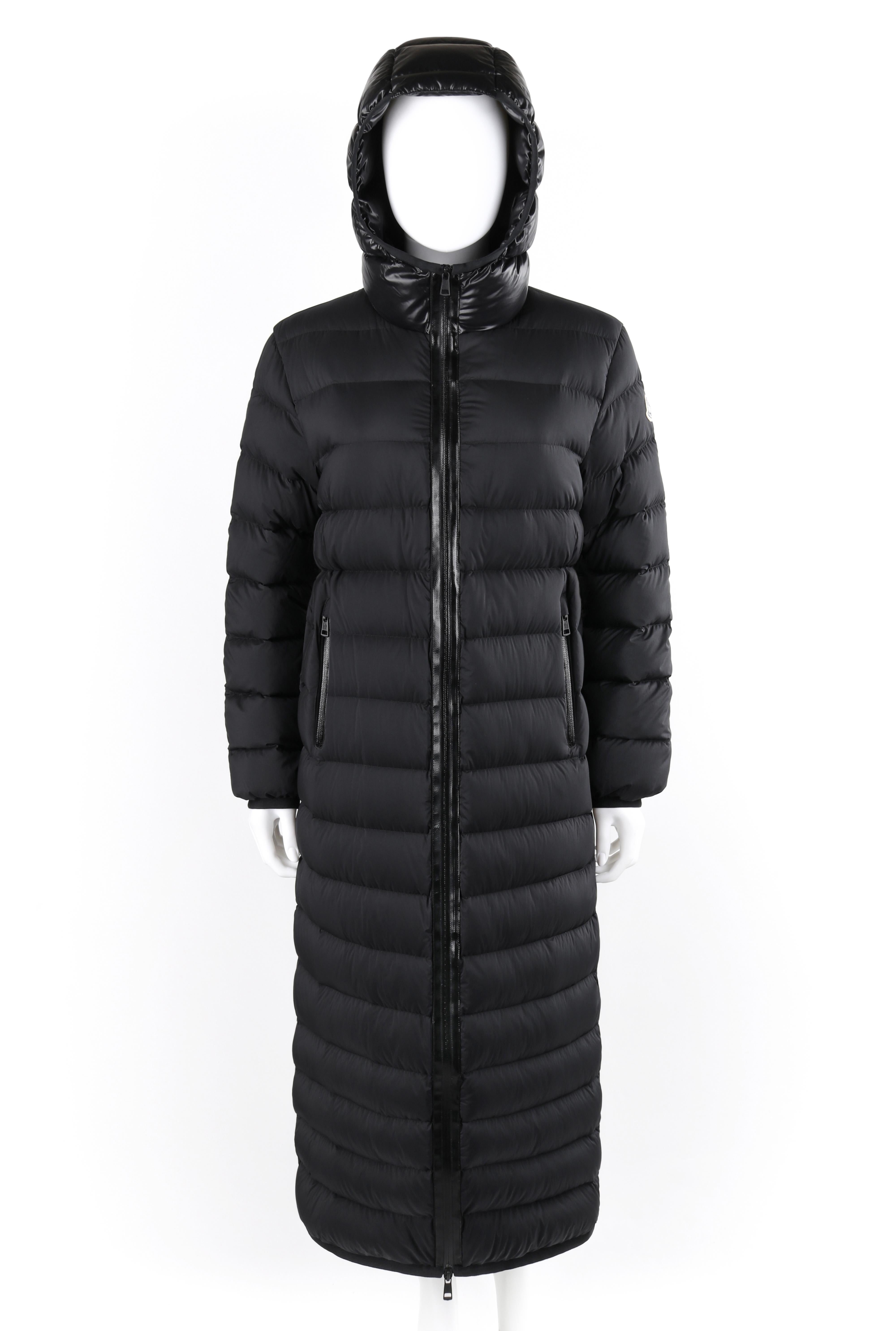 MONCLER F/W 2018 “Grue” Black Hooded Quilted Long Down Puffer Coat Jacket NWT
 
Brand / Manufacturer: Moncler
Collection: F/W 2018 Moncler Pierpaolo Piccioli 
Designer: Pierpaolo Piccioli 
Manufacturer Style Name: “Grue Long Down Puffer Coat”
Style: