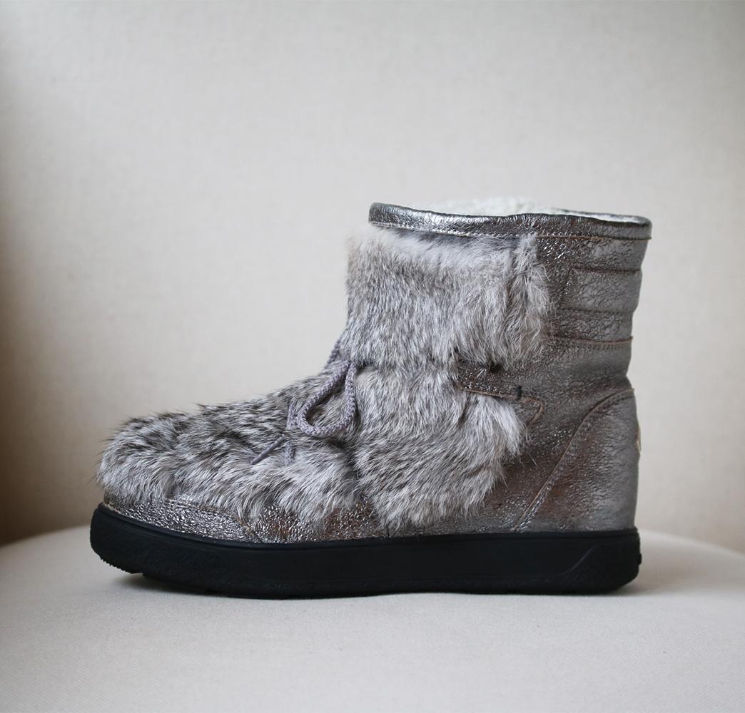 Dressing for colder temperatures doesn't have to come at the expense of looking chic, as shown here by Moncler. These boots are a winter staple in bright silver, combining textured leather, rabbit fur and a cool lace-up design. Round toe. Upper:
