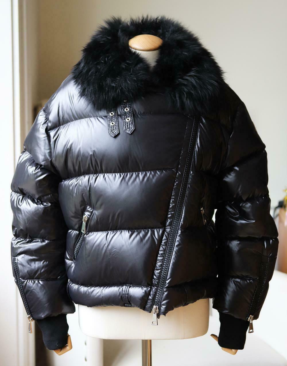 The brand uses the same techniques today for pieces like this jacket, which is cut from patent-shell and quilted to ensure optimum warmth.
It has a plush shearling collar and an asymmetric two-way zip fastening through the front.
Black patent-shell