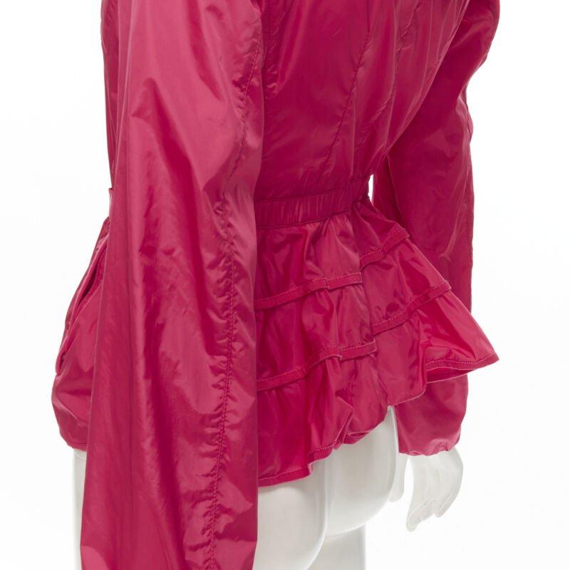 MONCLER Gazon Giubbotto pink back ruffles belted waist windbreaker jacket Sz 2 M
Reference: KNLM/A00061
Brand: Moncler
Model: GAZON GIUBBOTTO
Material: Polyamide
Color: Pink
Pattern: Solid
Closure: Belt
Lining:  Fabric
Made in: