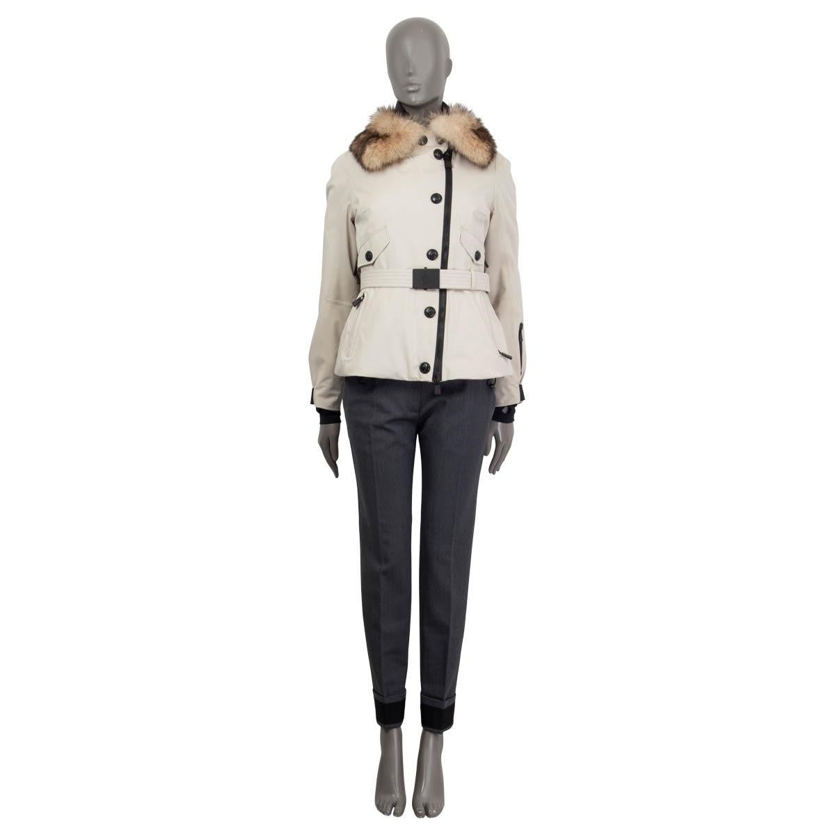 100% authentic Moncler 'Grenoble' belted ski jacket in sand polyamide (87%) and elastane (13%). Features a detachable fur collar, two zipped pockets on the sleeves, two buttoned chest pockets and two zipped pockets on the front. Opens with a zipper