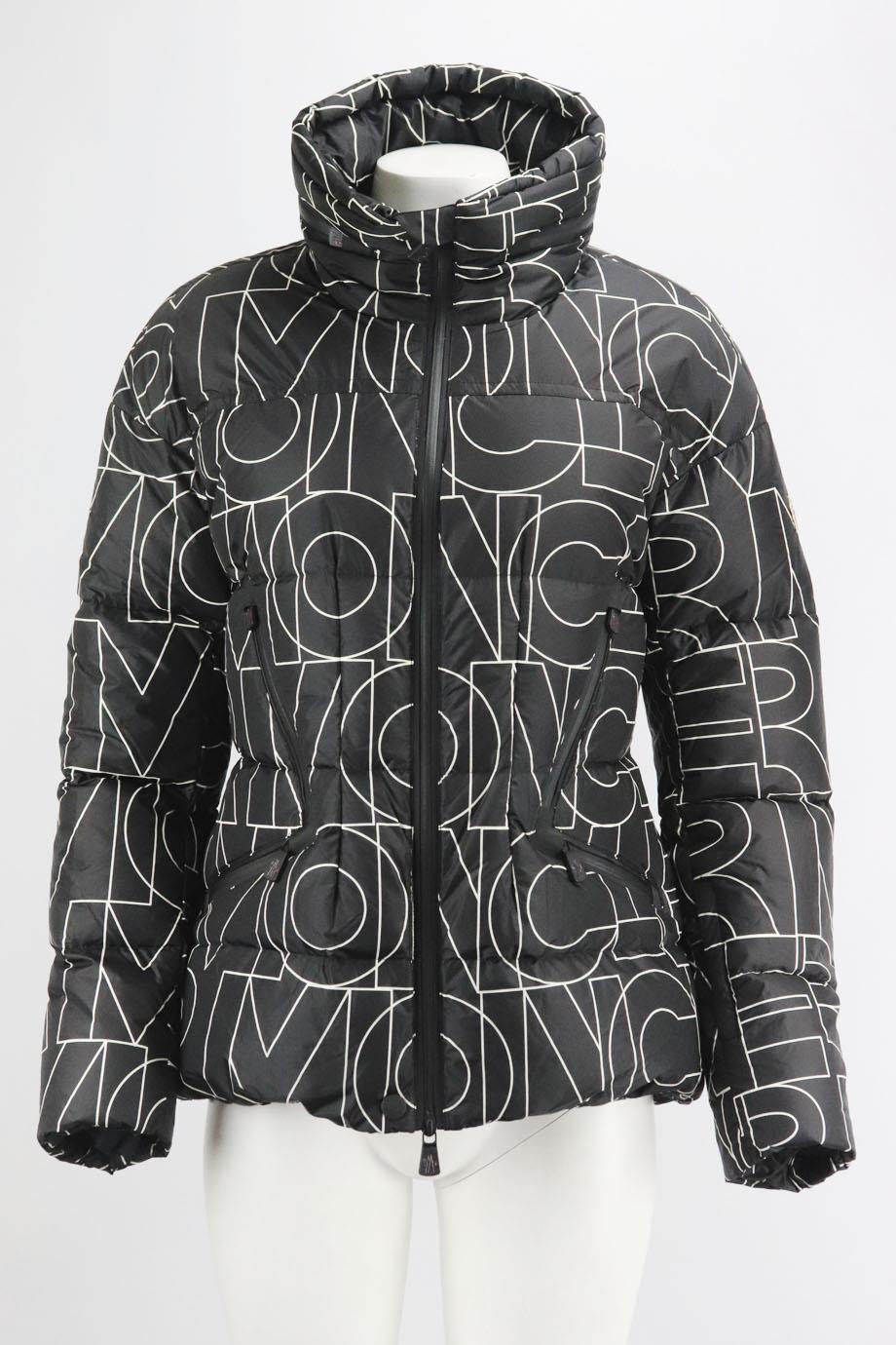 Moncler Grenoble Dixence printed quilted down ski jacket. Black and white. Long sleeve, turtleneck. Zip fastening at front. 100% Polyamide; lining: 100% polyester. Size: 4 (UK 14, US 10, FR 42, IT 46). Shoulder to shoulder: 21 in. Bust: 40 in.