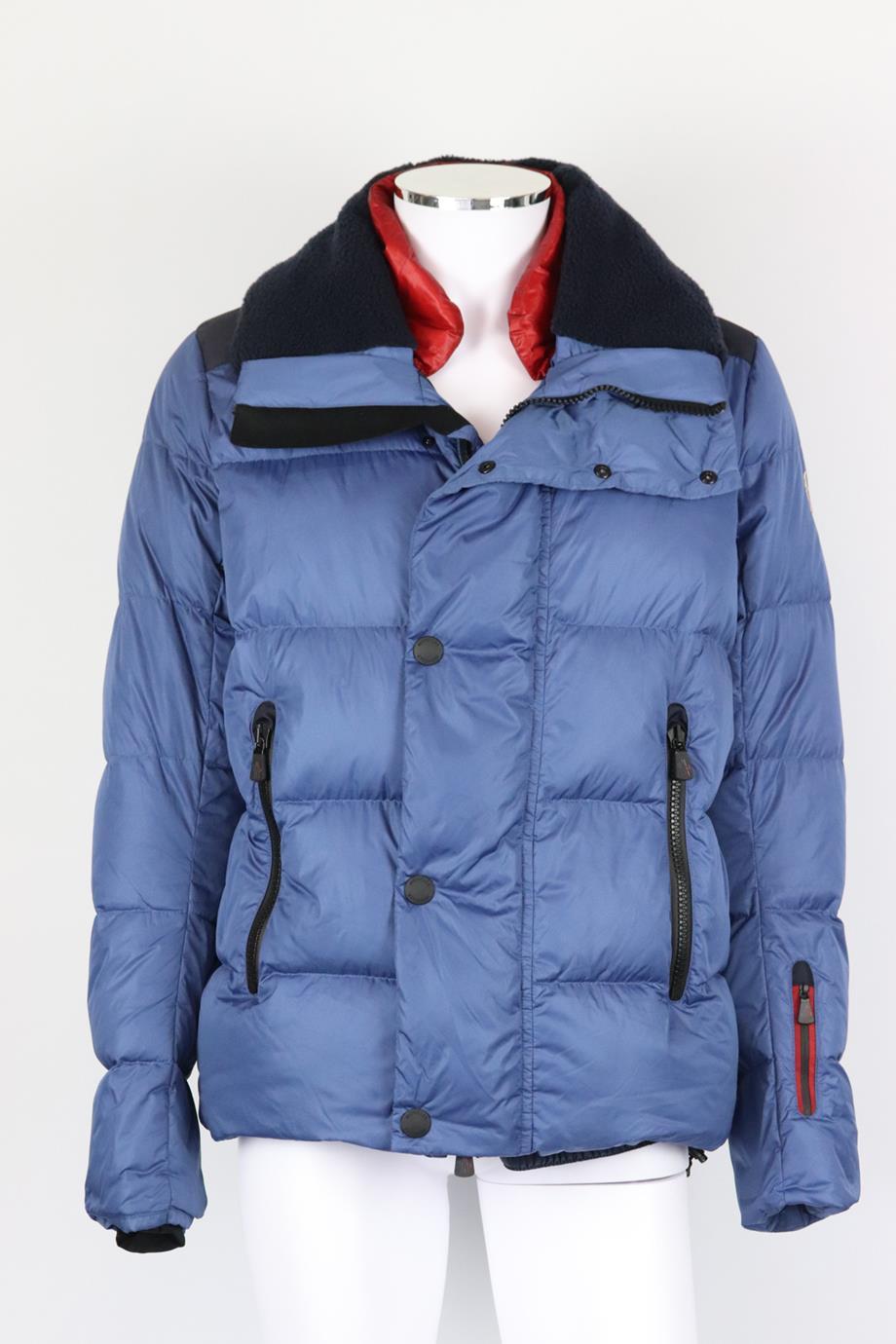 Moncler Grenoble Kobuk shearling trimmed quilted shell down jacket. Blue. Long sleeve, crewneck. Zip fastening at front. 100% Polyamide; fabric2: 100% polyester; fabric3: 83% polyamide, 17% elastane; filling: 90% down, 10% feather. Size: 5 (XXLarge,