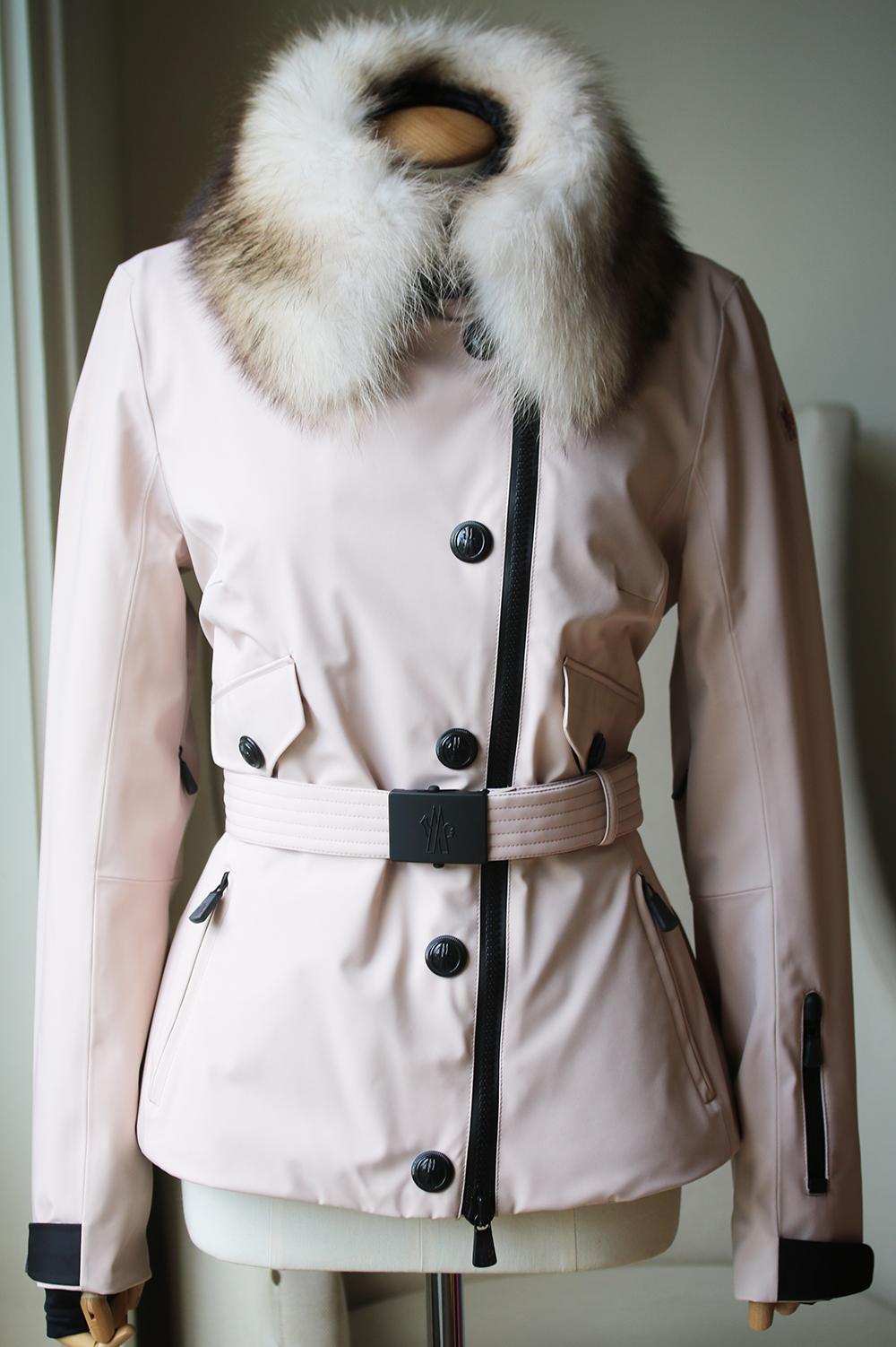 Removable fur-trimmed hood. Adjustable cuffs. Thumb hole sleeves. Pocket at sleeve. Front pockets. Belted waist. Interior eyewear cleaner and pocket. Elasticized inner waistband. Zipper and snap closure. Shell: 100% nylon. Lining: 100% nylon. Fill: