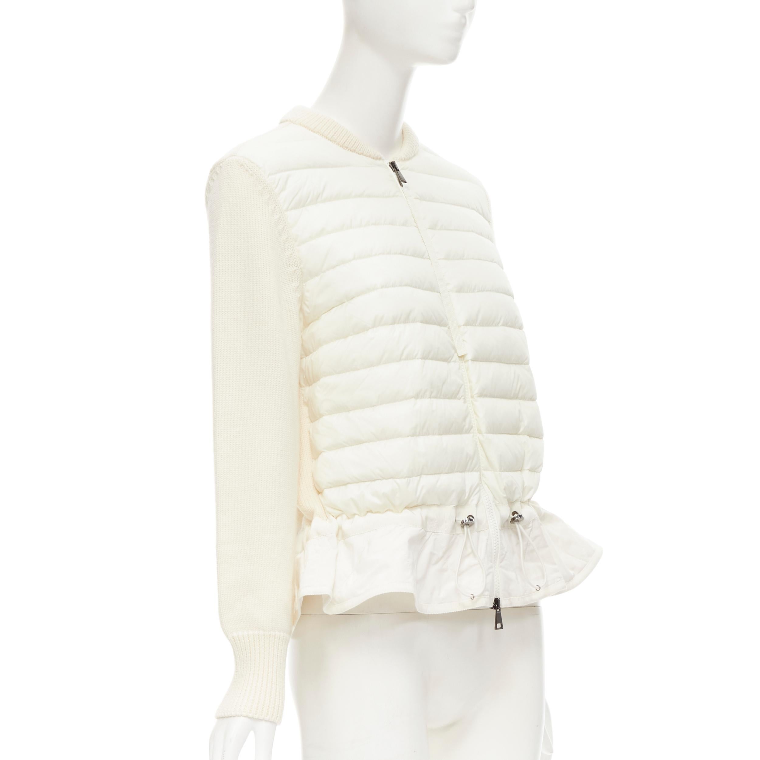 MONCLER Maglione Tricot cream down padded peplum wool cardigan L 
Reference: JYLM/A00017 
Brand: Moncler 
Material: Wool 
Color: Cream 
Pattern: Solid 
Closure: Zip 
Extra Detail: Dual zip front. Signature Moncler emblem on left sleeve. Nylon down