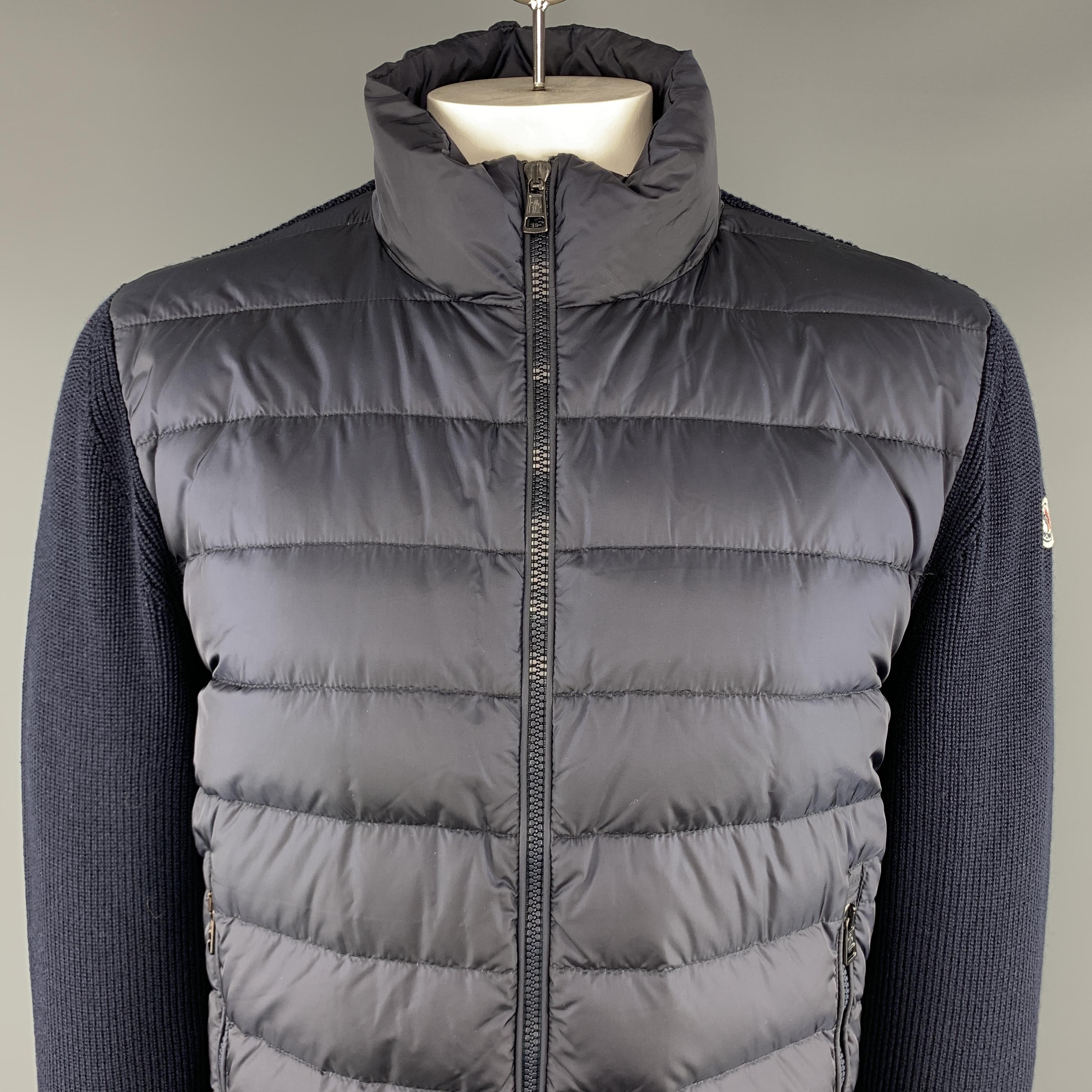 MONCLER Maglione Tricot Jacket comes in navy tones in a knitted acrylic and quilted nylon materials, with a high collar, a full zip. zip pockets and ribbed cuffs and hem. Made in Romania.

Excellent Pre-Owned Condition.
Marked: