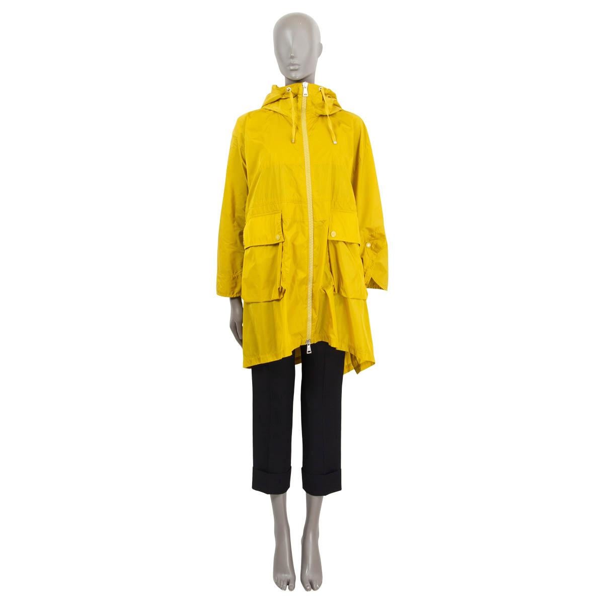 100% authentic Moncler high-low raincoat in mustard polyamide (100%). Features two front flap pockets and a drawstring hood. Opens with a yellow zipper on the front and yellow push-buttons on the side. Has been worn and is in excellent condition. 