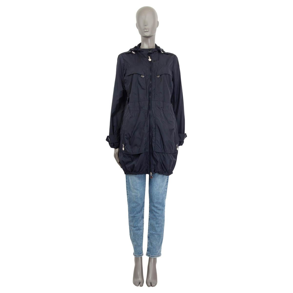 100% autentico Moncler, giacca svasata con cappuccio in poliammide blu navy (100%). Impreziosito da un orlo in broderie anglaise. Presenta due tasche con patta e bottone sul davanti, una tasca con bottone e una tasca con zip sulla manica. Si apre