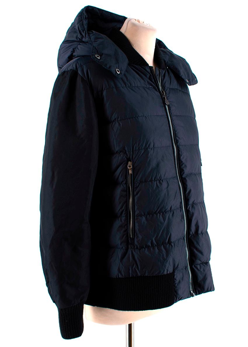 Moncler Navy Bomber Style Down Hooded Jacket 

-Gorgeous classic bomber style to the front 
-Wool to the back 
-Detachable hood 
-Pleat detail to the back 
-Ribbed cuffs, hem and collar  
-Zip fastening to the front 
-2 zipped pockets to the front