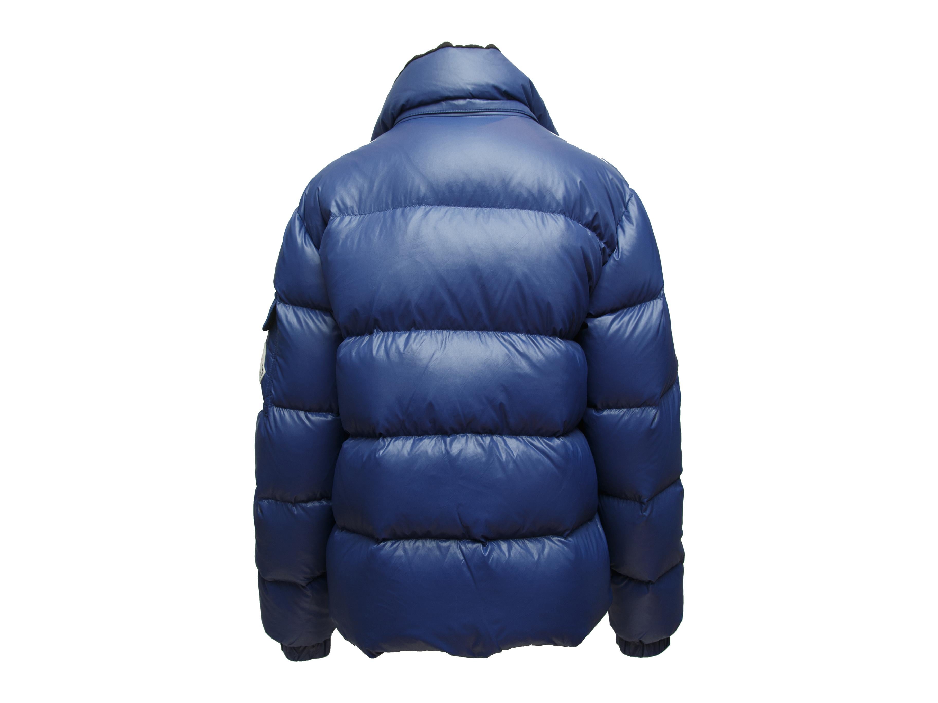 Product details: Navy blue down-filled puffer jacket by Moncler. Dual hip pockets. Zip closure at center front. Designer size 6. 36