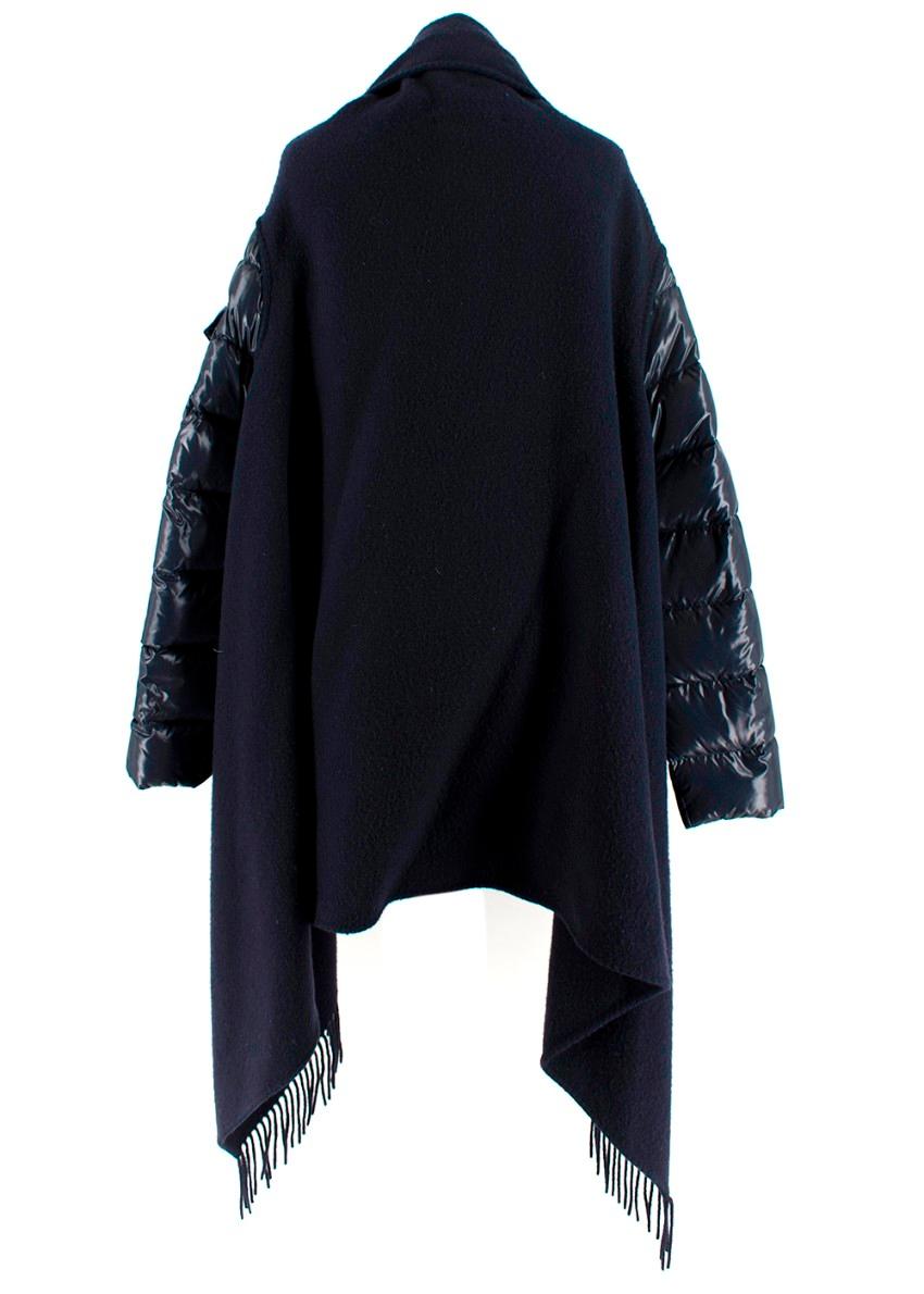 Moncler Navy Mantella Cape 

- Constructed with a layered wool detail to the main body along with padded sleeves
- Tasselled fringe to the edges gives bohemian feel

PLEASE NOTE, THESE ITEMS ARE PRE-OWNED AND MAY SHOW SIGNS OF BEING STORED EVEN WHEN