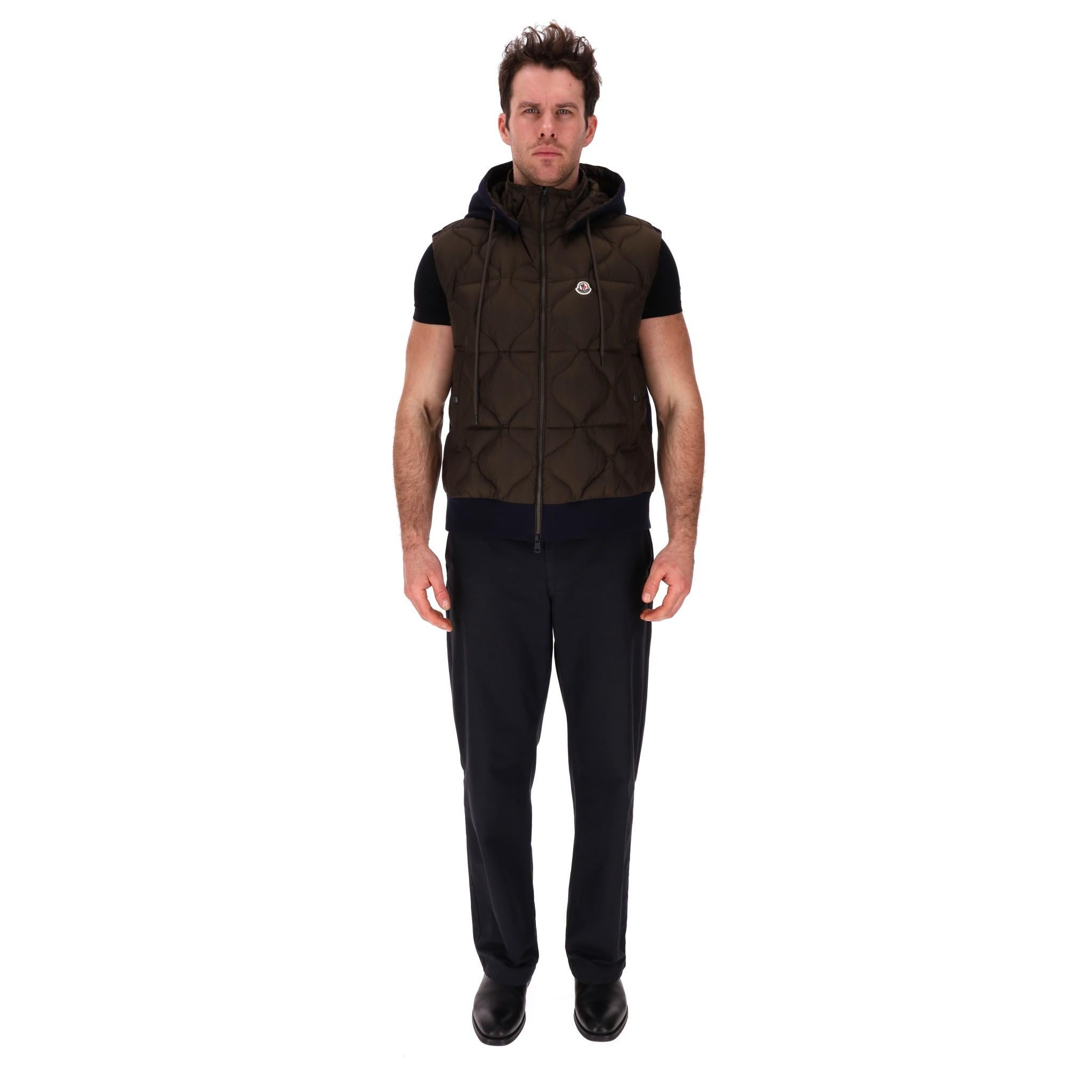 Moncler Padded Down Gilet

Hooded gilet filled with down and feathers designed with khaki padded front and navy, fleece fabric to rear.

'Moncler' logo embroidery to the chest, snap side pockets and centre zip closure.

Rrp Approx. £900

Size –