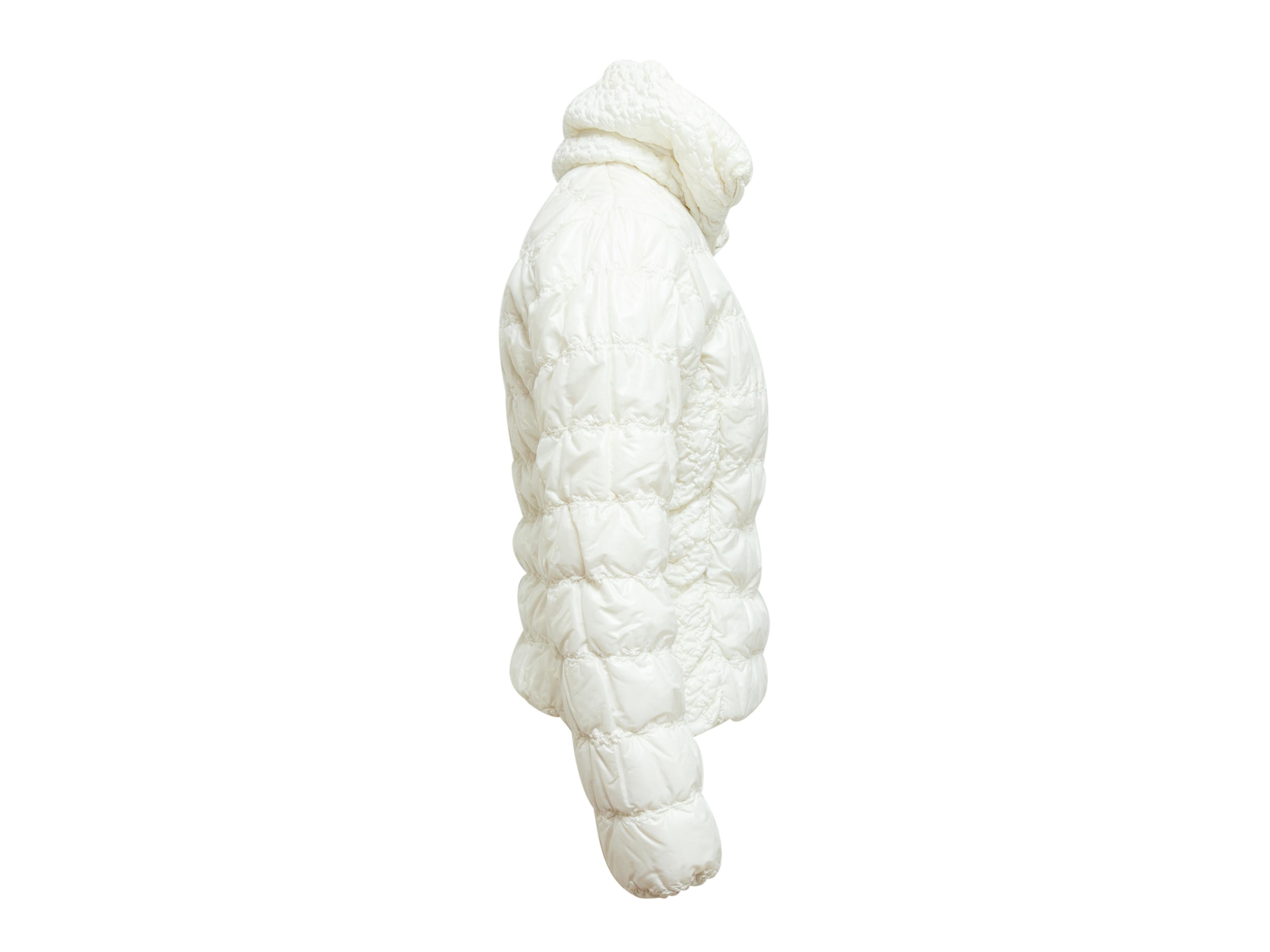 Product details: Pearl white puffer jacket by Moncler. High collar. Zip closure at center front. Designer size 1. 36