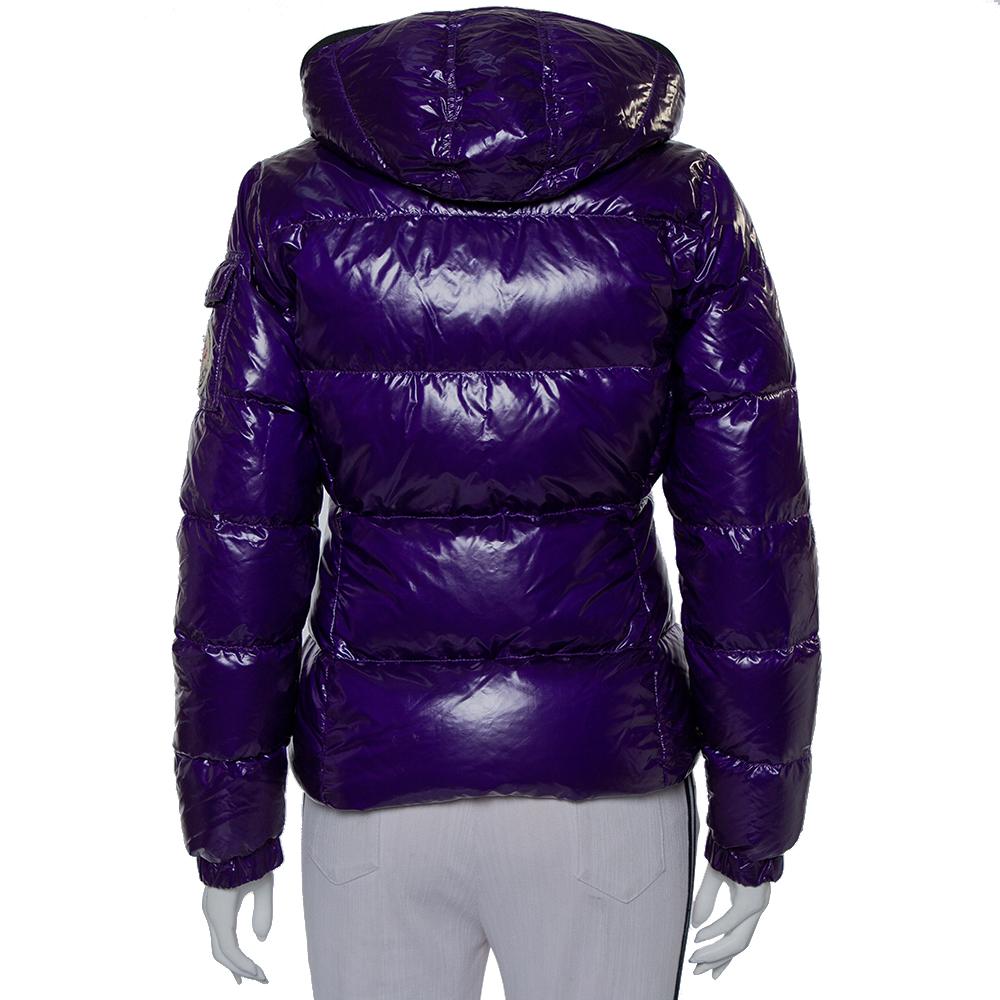 Ace an ultra-stylish sporty look in this hooded jacket from Moncler. The purple quilted creation features a high-collared neckline, a front zip closure, two external pockets, and long sleeves. Chic and stylish, it is sure to lend you a fantastic