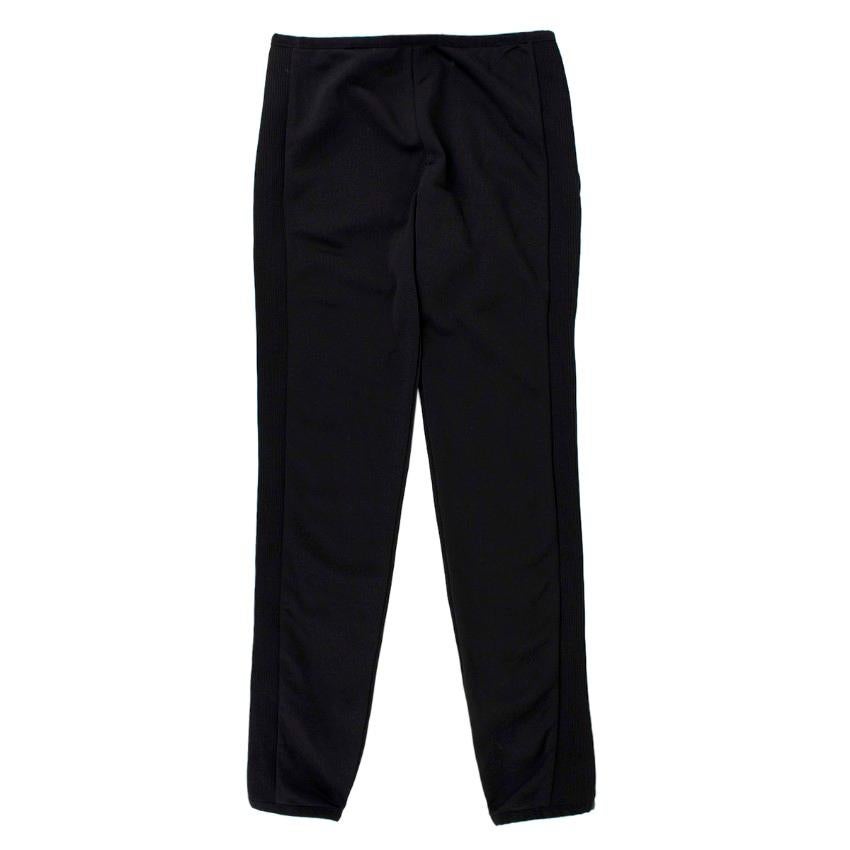 Moncler Ribbed Skinny Trousers

- Stretch fabric
- Elastic waistline and hem
- Ribbed side panels
- Tight-fit
- Signature logo tag at back waistline

Please note, these items are pre-owned and may show some signs of storage, even when unworn and