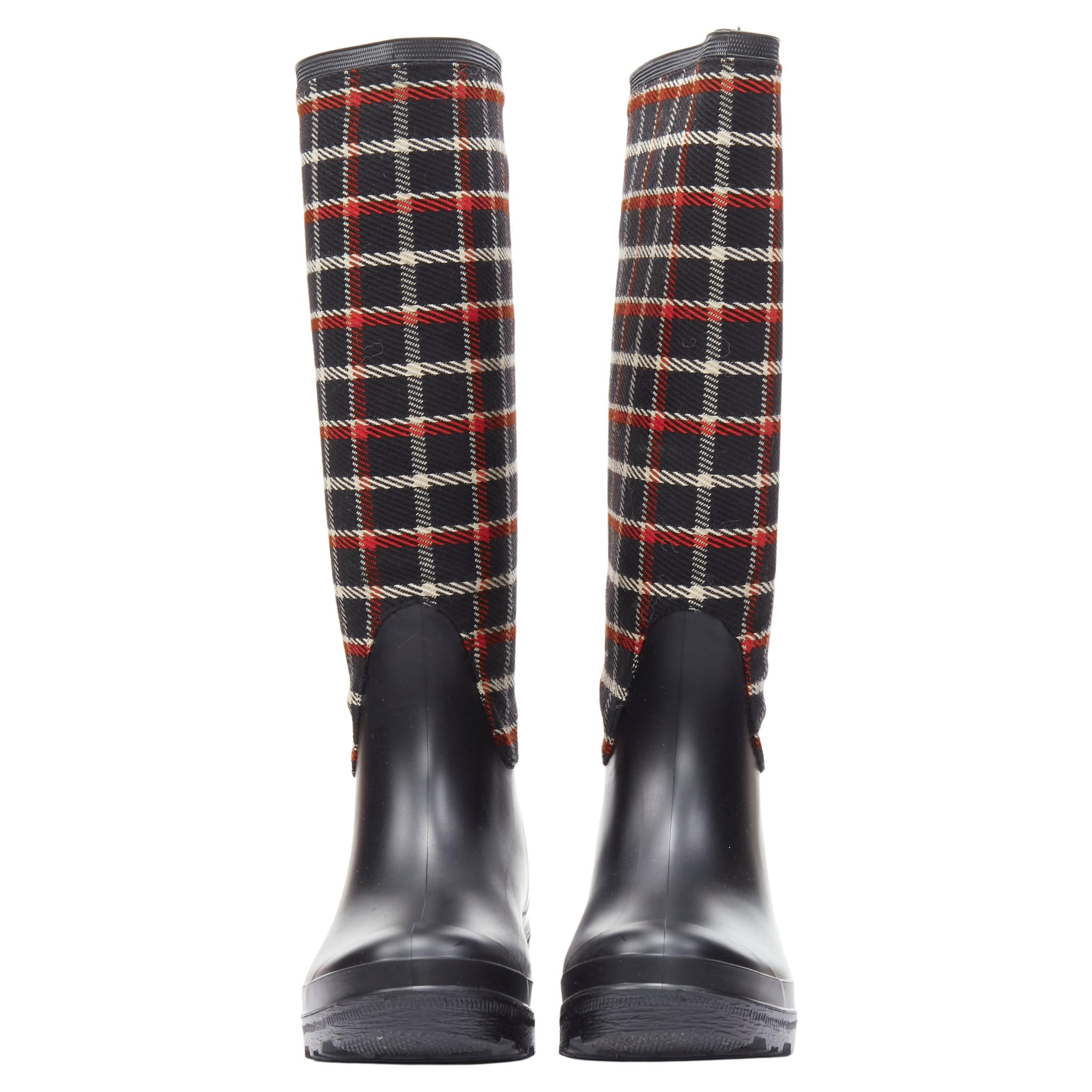 MONCLER Runway red black plaid check black rubber wellington rain boots EU39 
Reference: MELK/A00231 
Brand: Moncler 
Collection: 2015 Runway 
Material: Rubber 
Color: Black 
Pattern: Plaid 
Extra Detail: Logo on heel. 
Made in: Italy 

CONDITION: