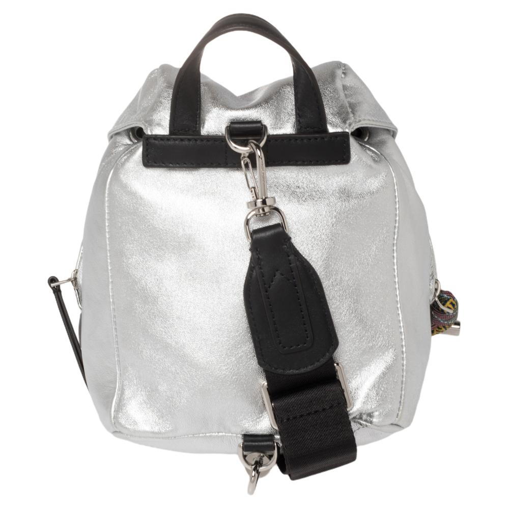 This silver-tone logo patch detail backpack from Moncler features a metallic sheen, a logo patch to the front, a single top handle, two zip-fastening pockets, buckle fastening, drawstring fastening, main compartment, and a single shoulder strap. It